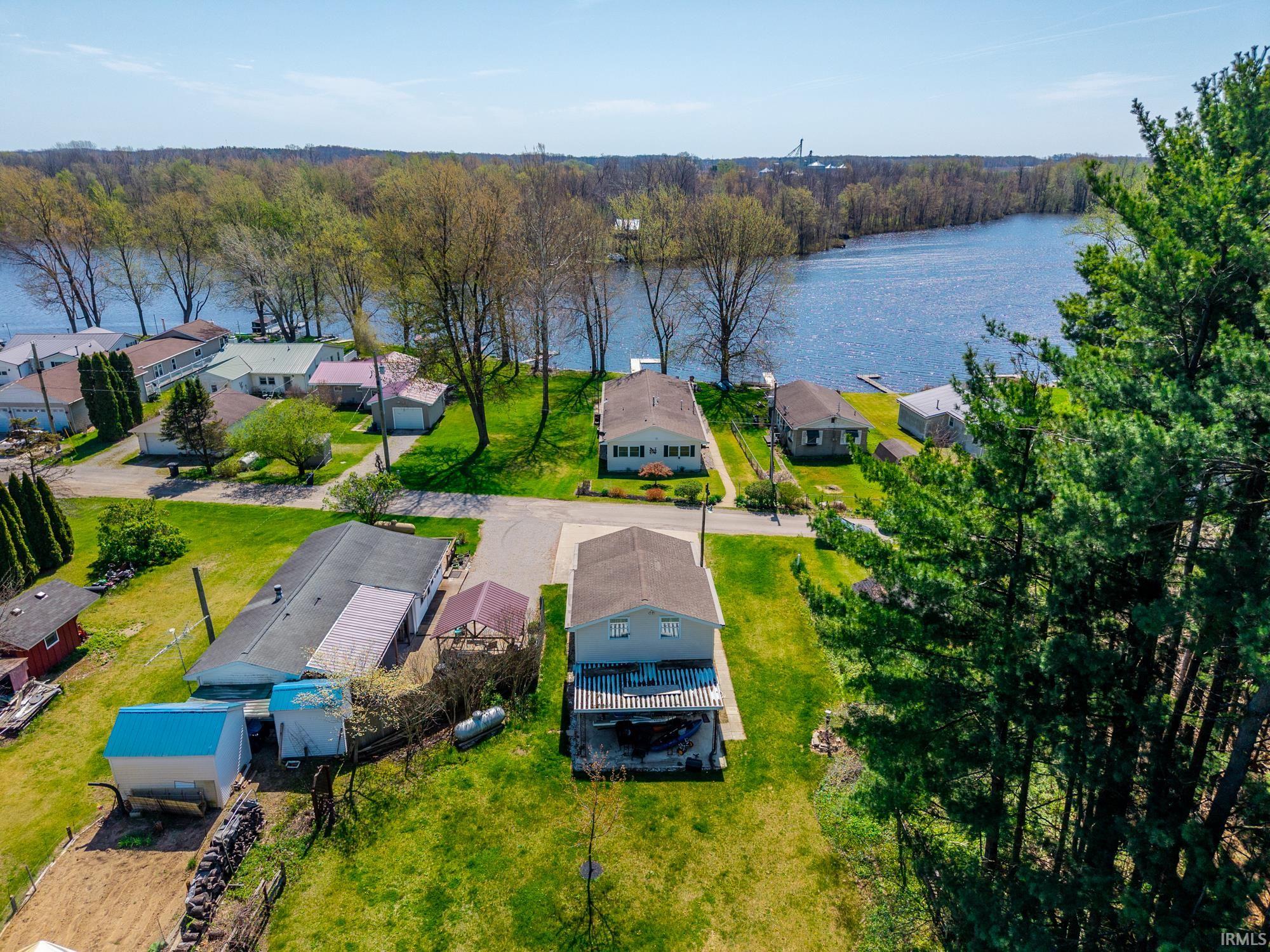 Aerial perspective showcasing waterfront properties with mature trees