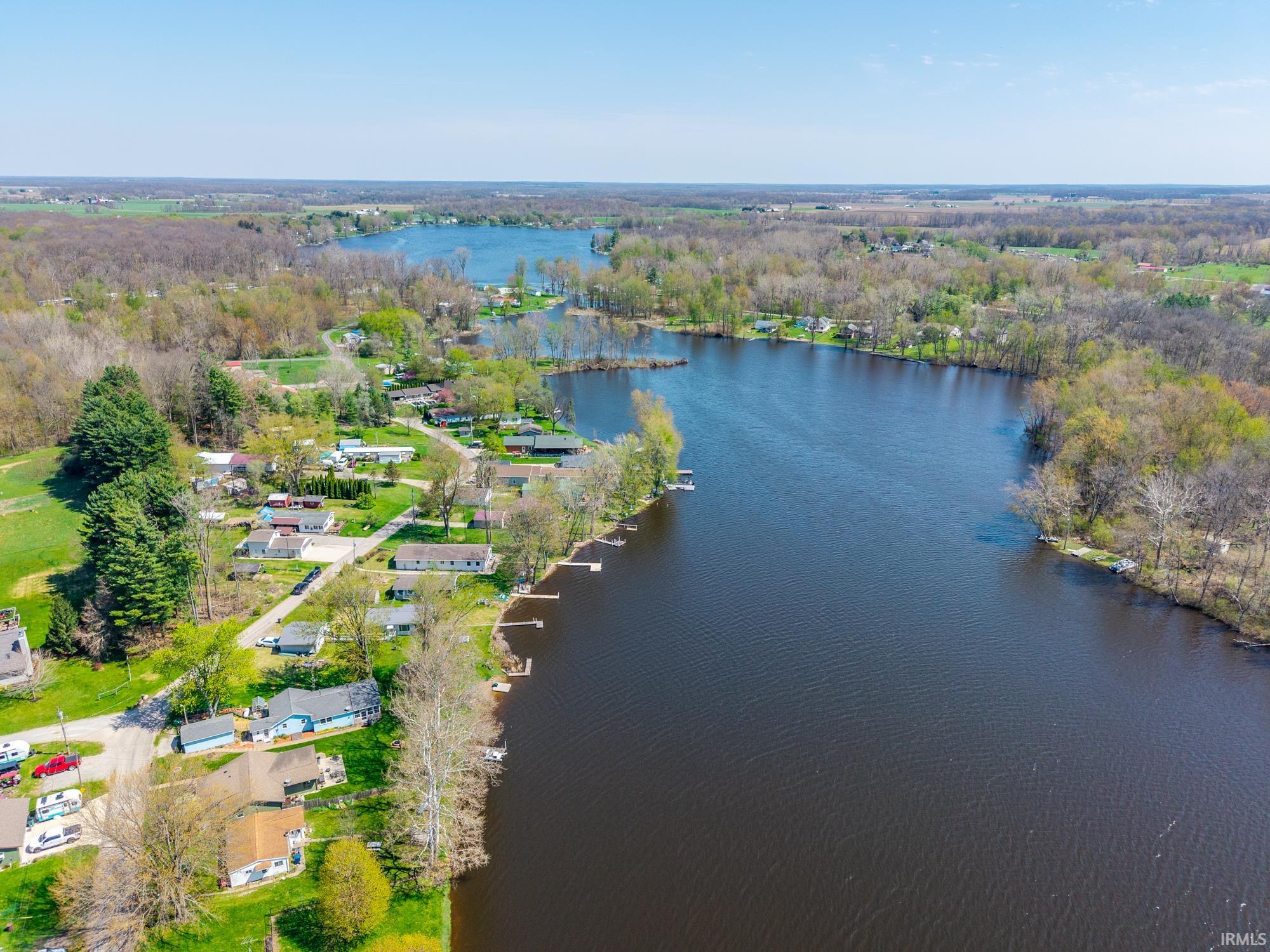 Expansive lake with multiple docks and surrounding wooded areas