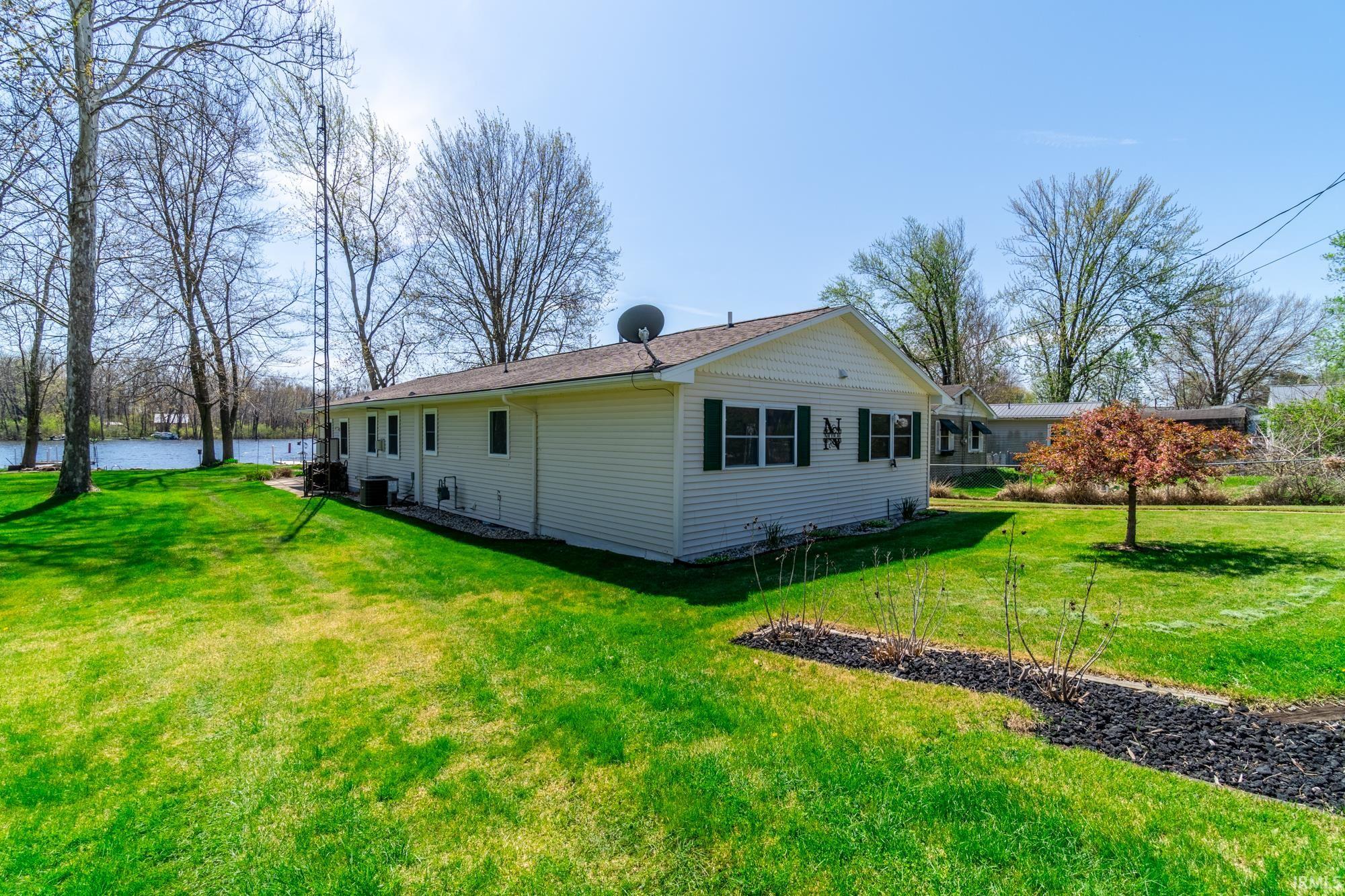 White siding exterior with dark green shutters