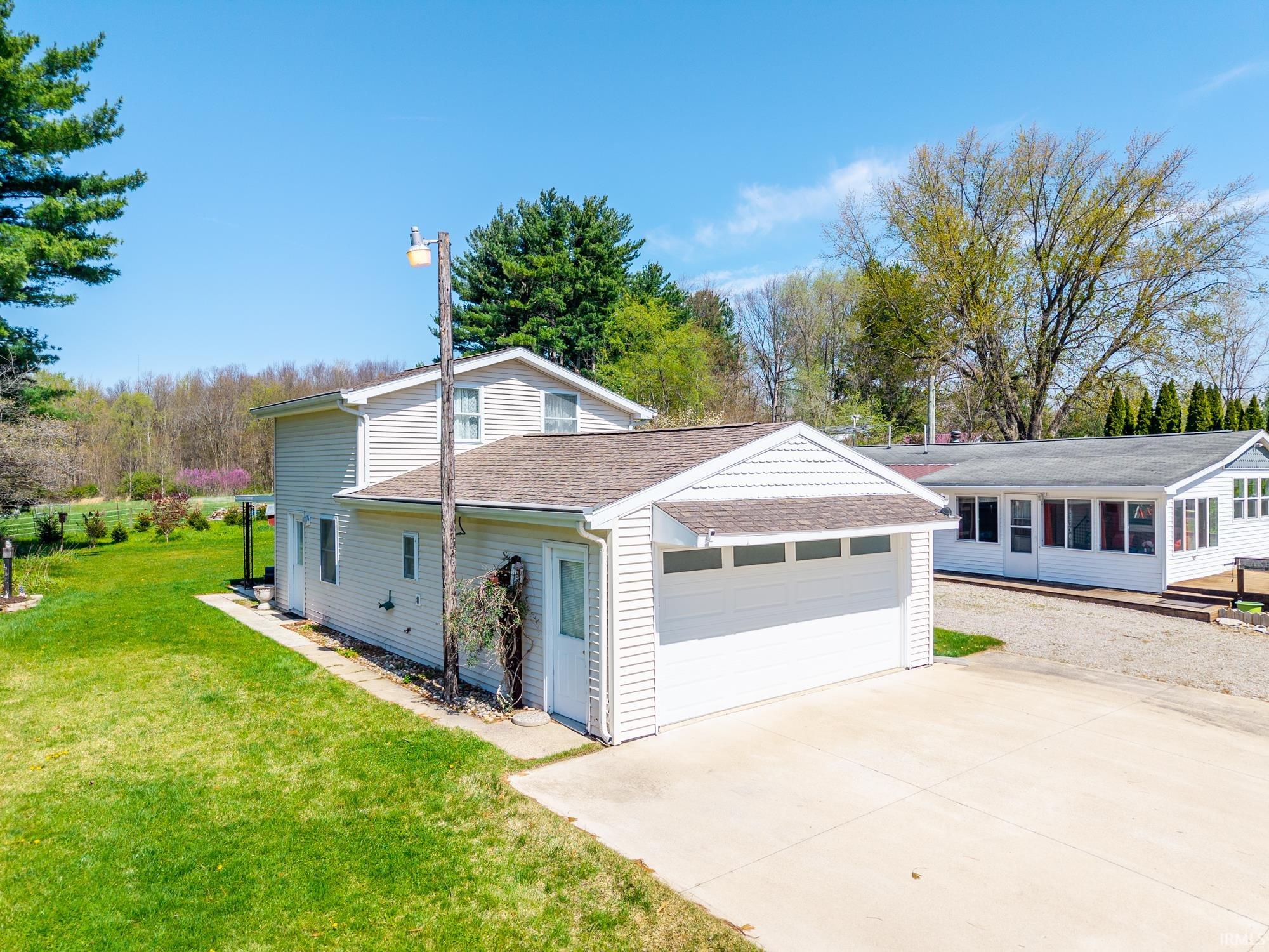 Detached two-story residence with light-colored siding