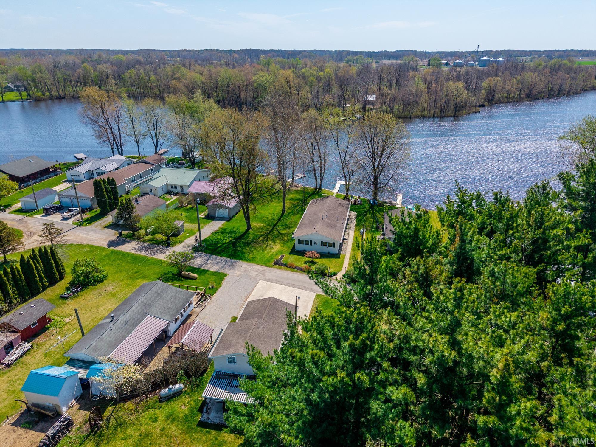 Aerial perspective showcasing multiple properties along a substantial waterway
