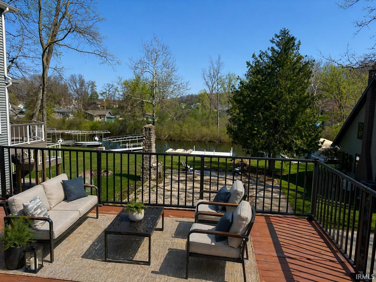Expansive outdoor deck featuring wood-finish flooring and black metal railings