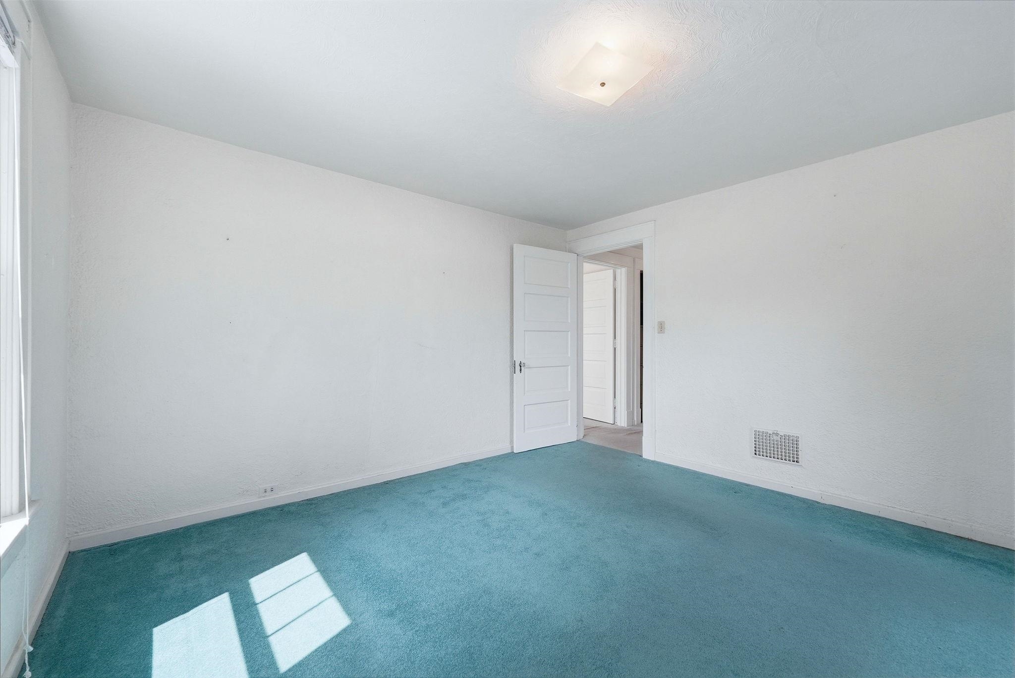 Room featuring light-colored walls and a textured ceiling
