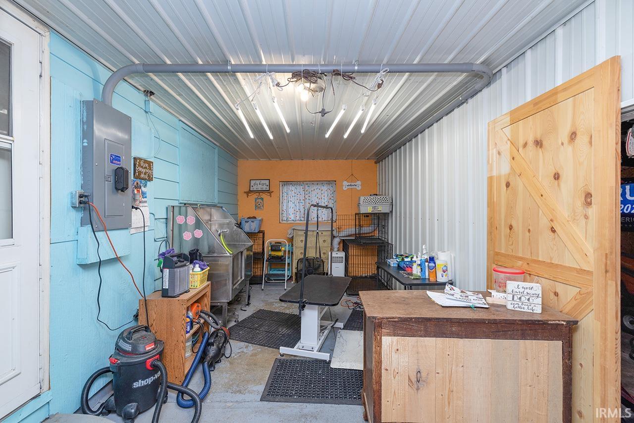 Garage with electric panel and metal wall
