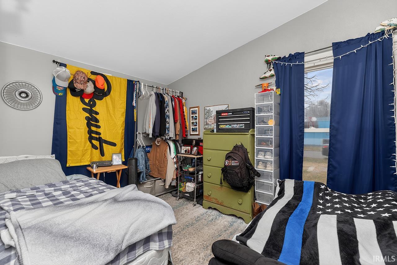 Bedroom featuring lofted ceiling