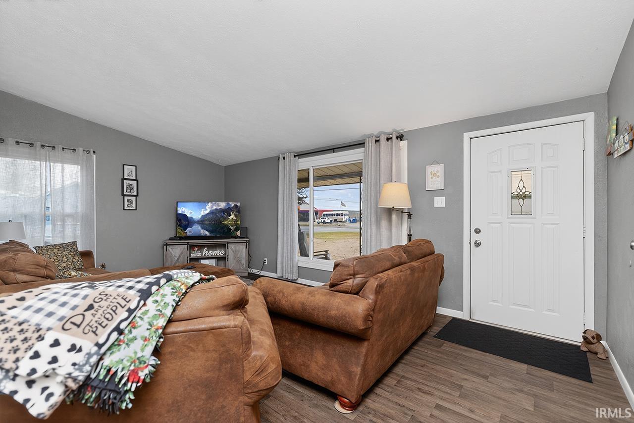 Living area featuring lofted ceiling and wood finished floors