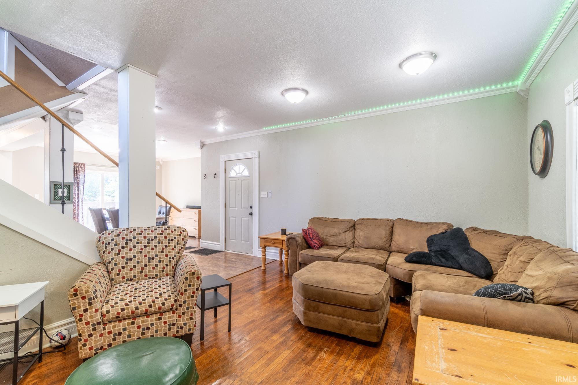 Warm wood-finish flooring extends through this living space