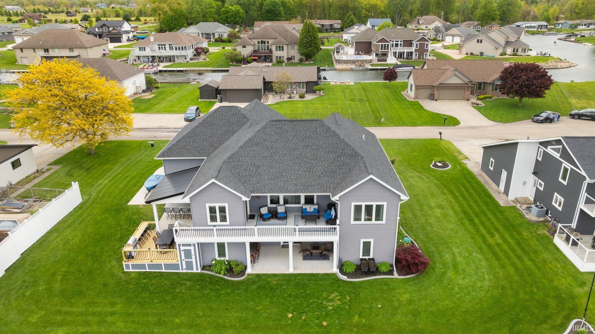 Two-story residence featuring gray siding and a dark shingle roof