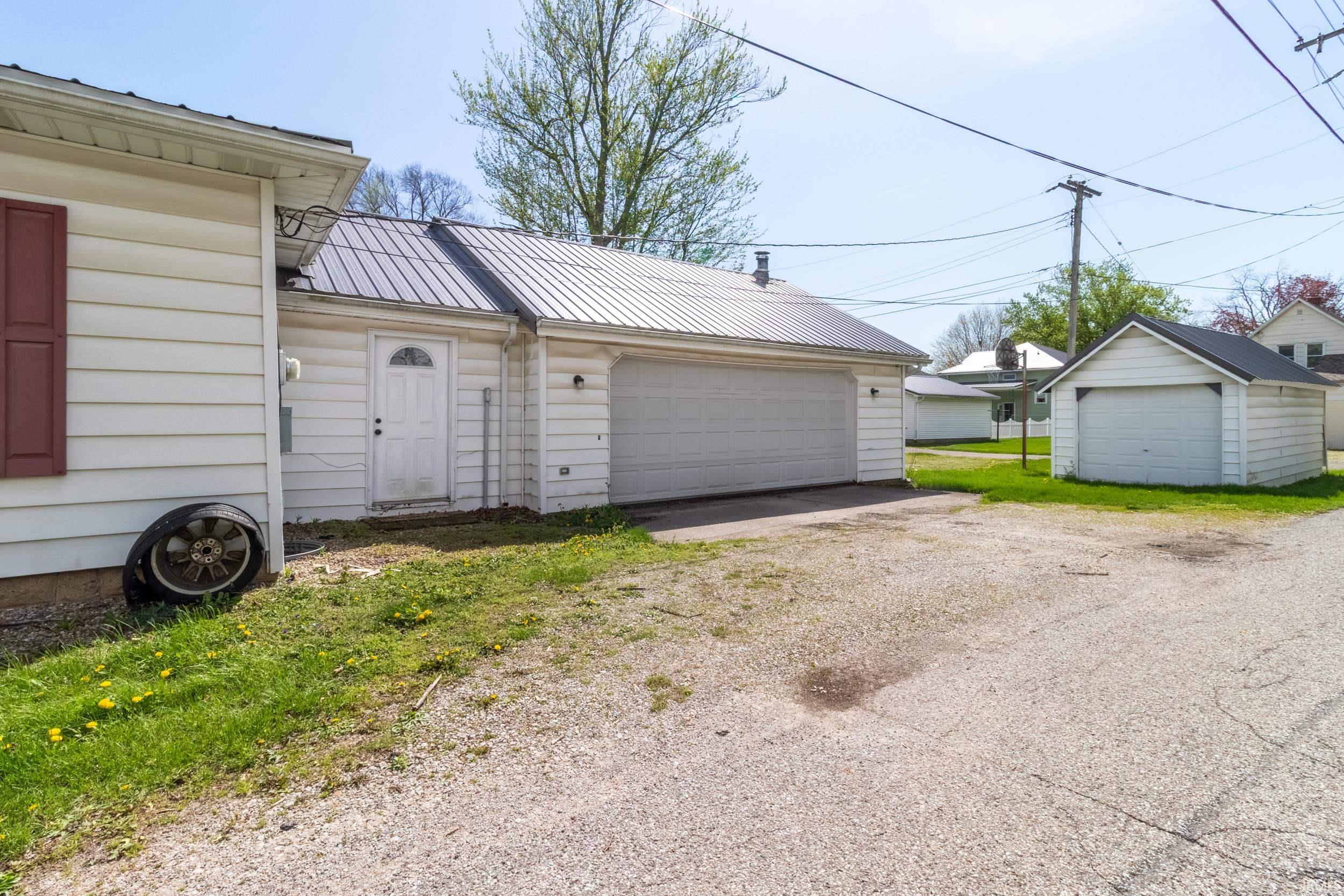 Two-car garage with metal roofing and an additional detached single-car garage