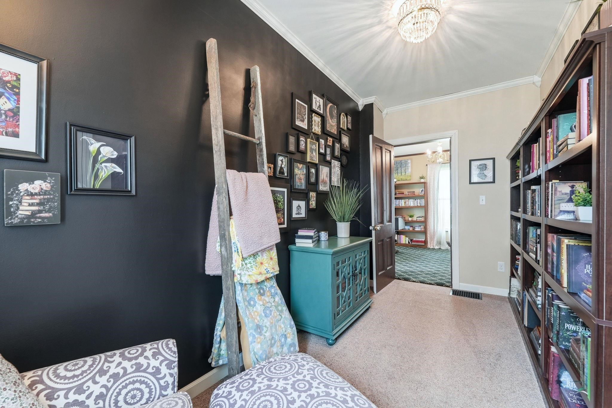 Custom built-in shelving with crown molding, deep wood-finish panels, and ample storage