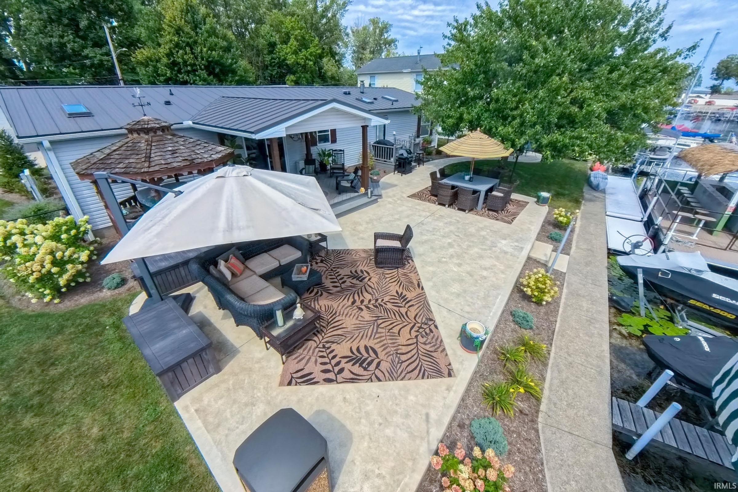 Expansive concrete patio with multiple outdoor living areas
