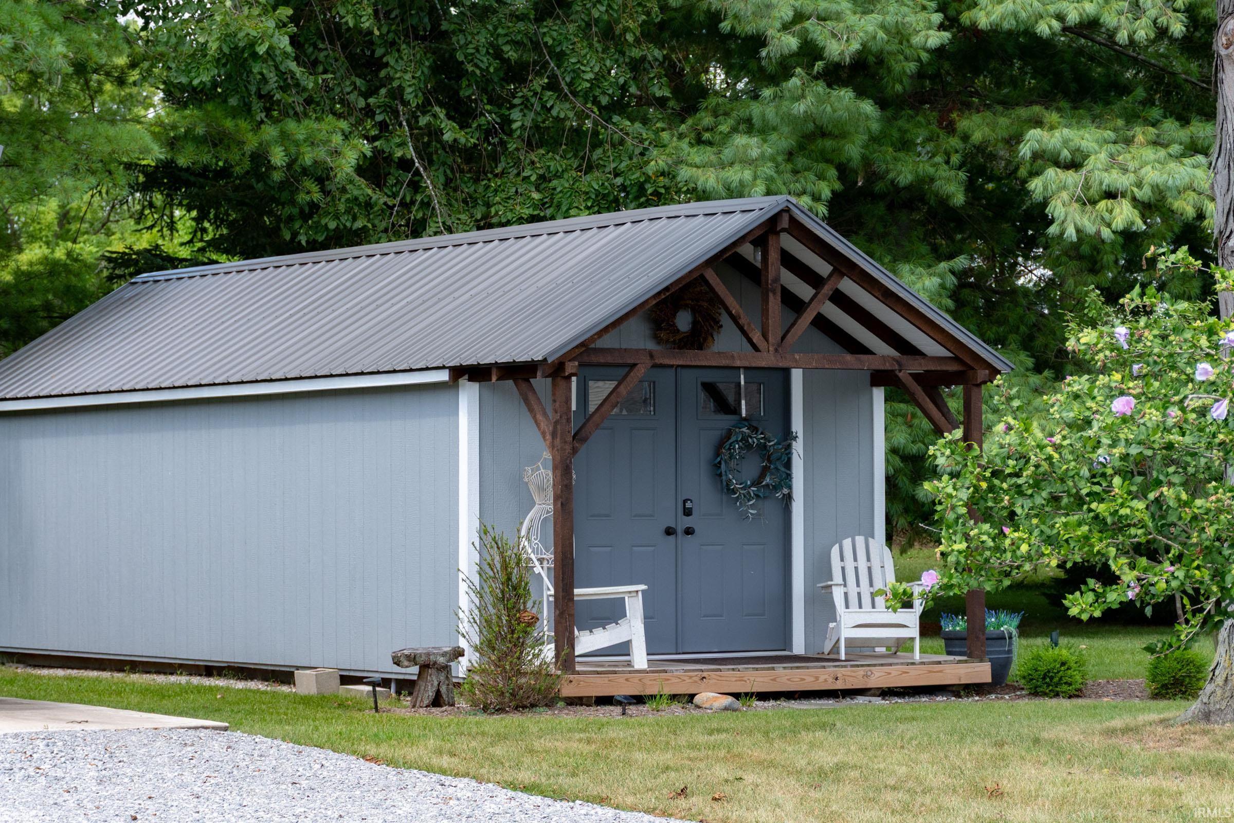 Light blue board-and-batten style siding with a dark gray metal roof
