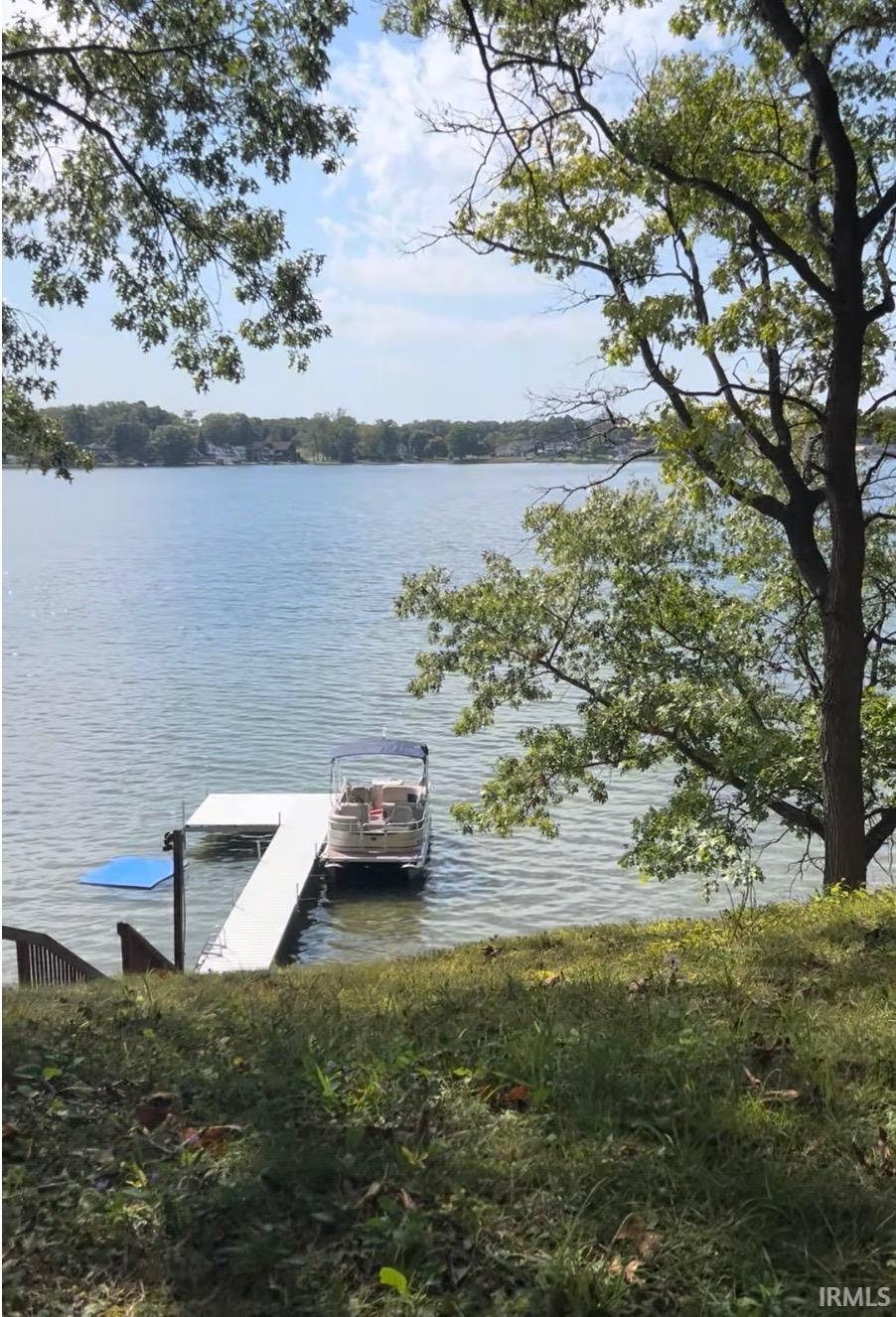 Waterfront property featuring a private dock with boat lift