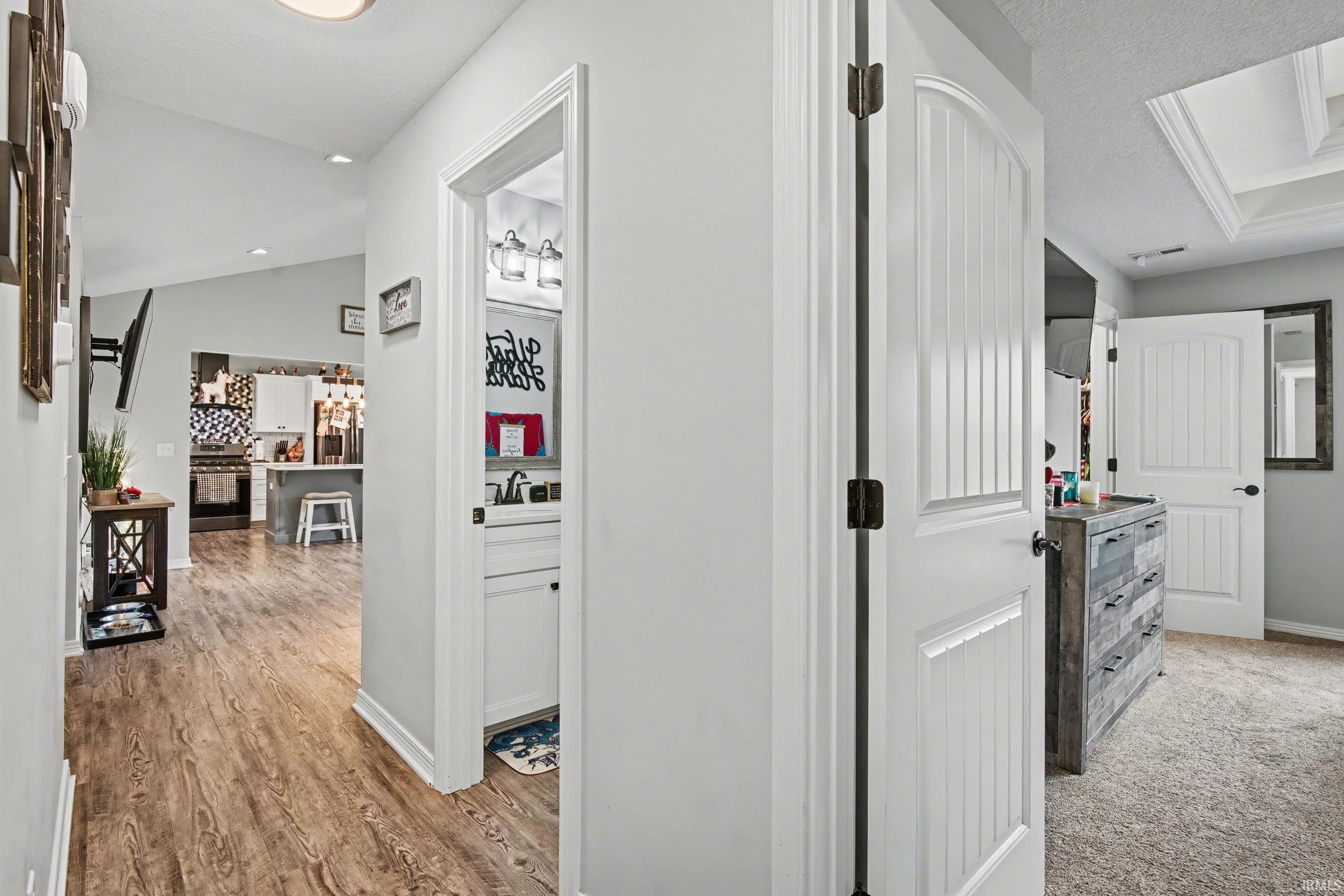 Open floorplan featuring wood-finish flooring and vaulted ceilings