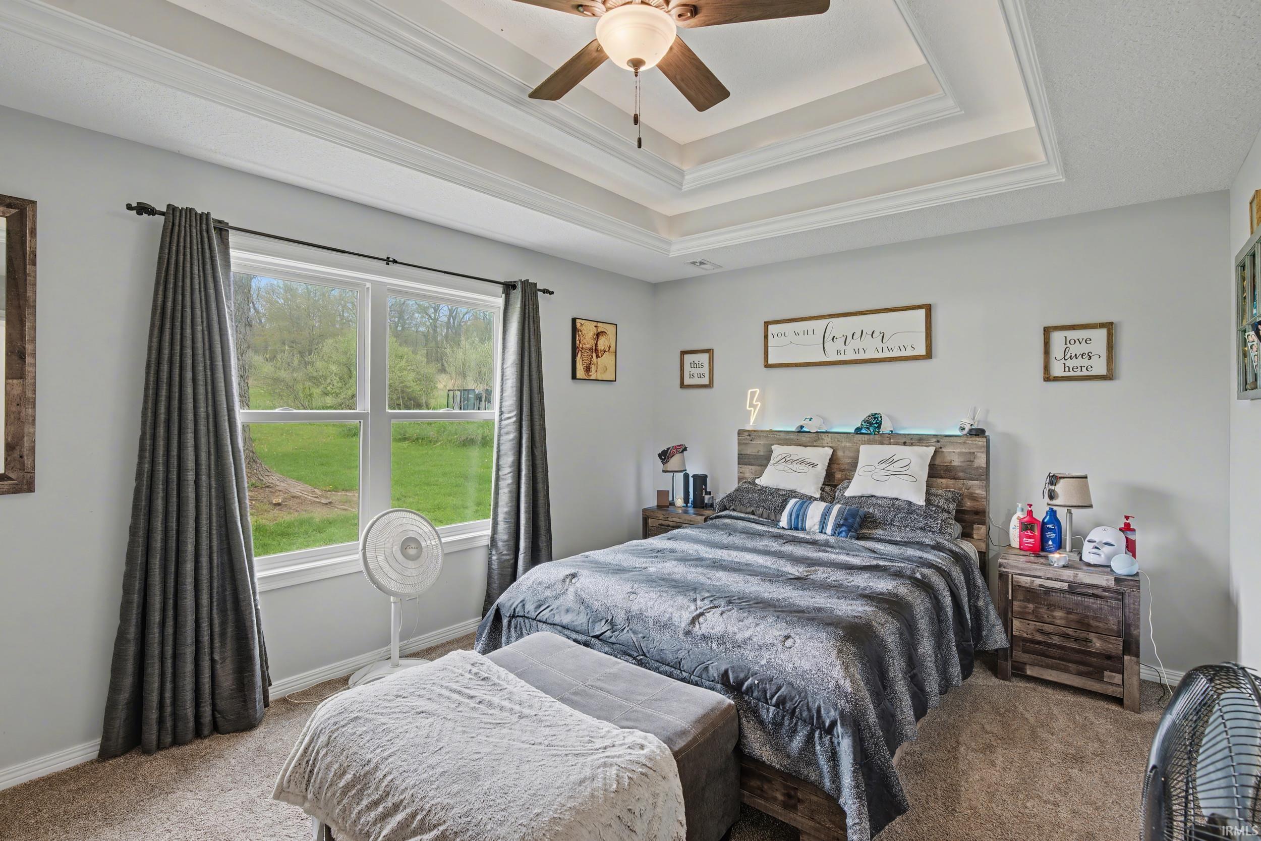 Recessed tray ceiling with crown molding and a ceiling fan with integrated lighting