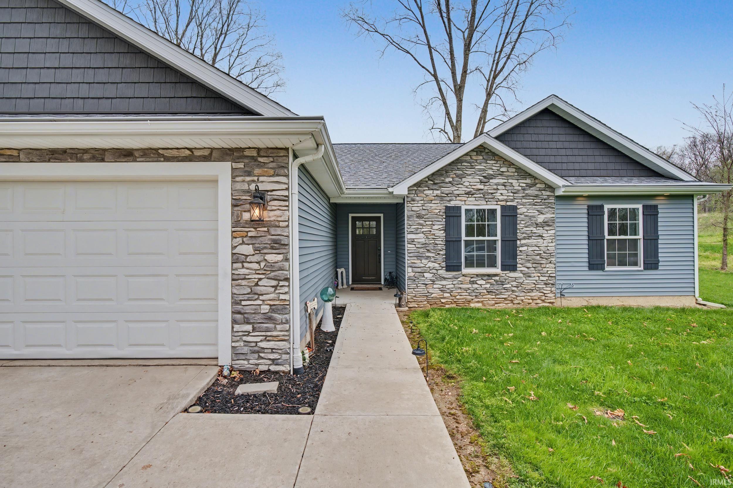 Exterior featuring stone veneer and light blue siding