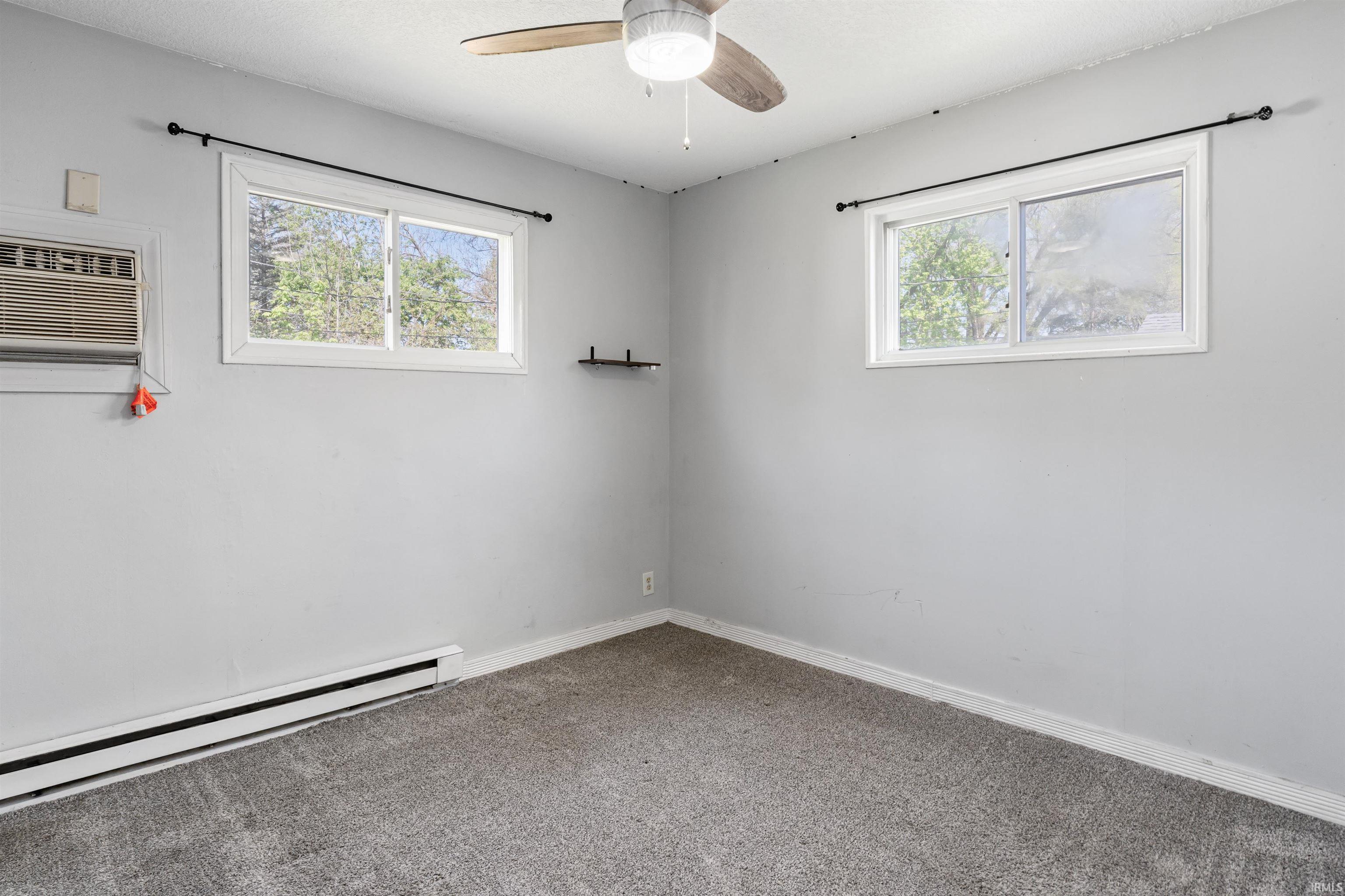 Carpeted room with light gray walls