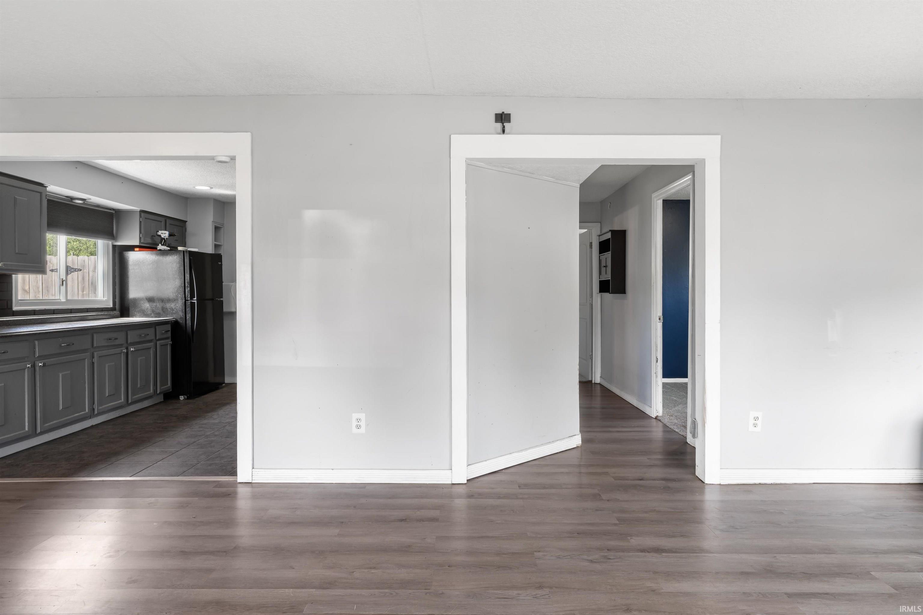 Wood-finish flooring throughout, complemented by light gray walls