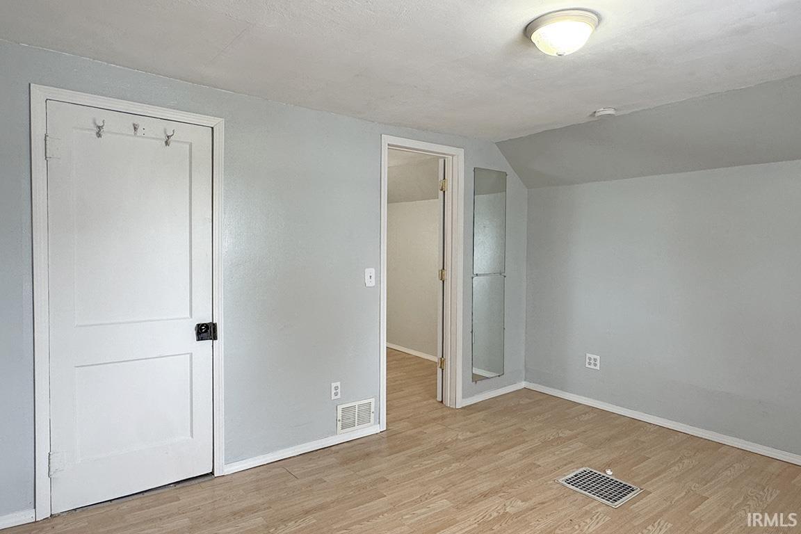 Room featuring light wood-finish flooring and light gray painted walls