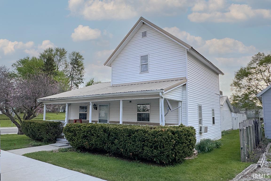 White siding exterior with a light-colored metal roof