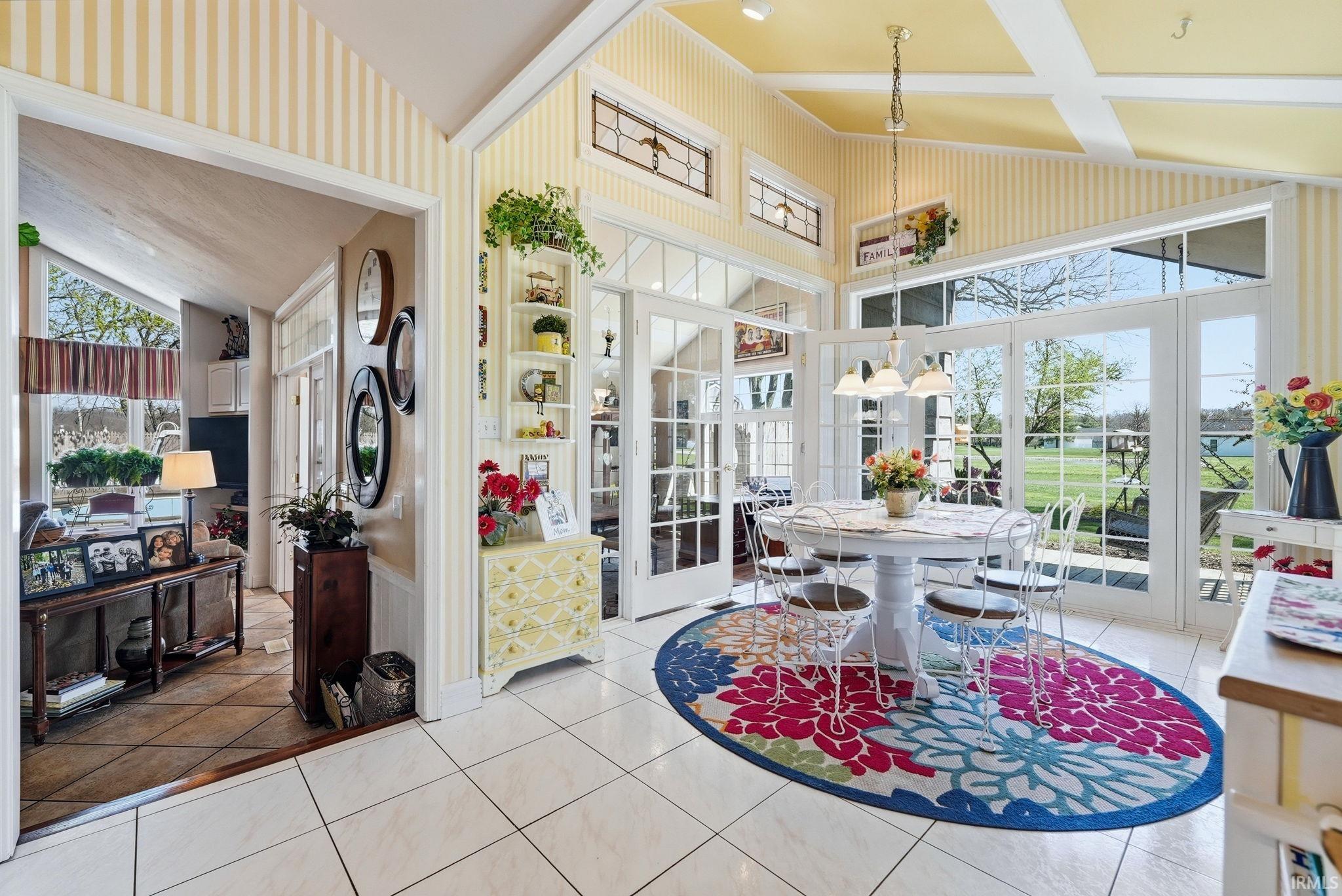 Eating area with french doors, vaulted ceiling, and plenty of natural light