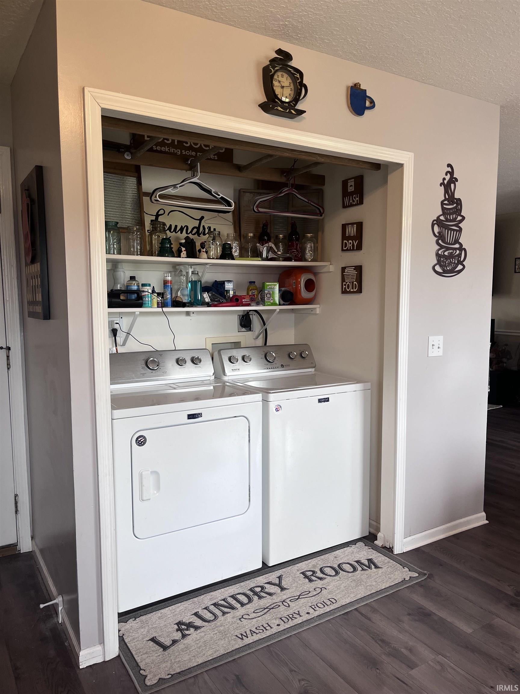 Dedicated laundry area featuring a white washer and dryer pair
