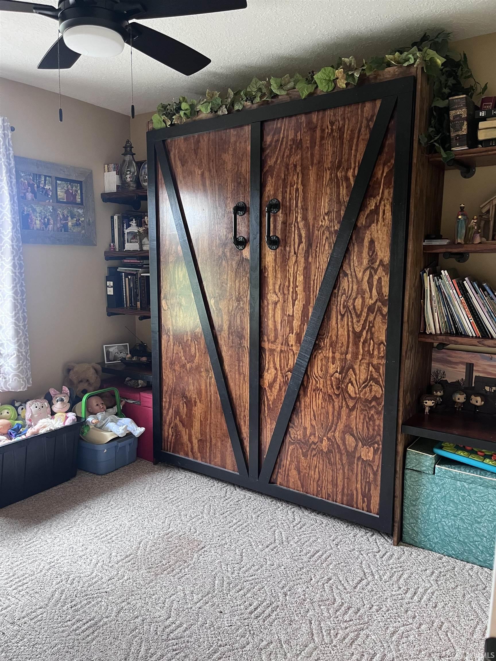 Built-in wood-finish cabinetry featuring dark hardware