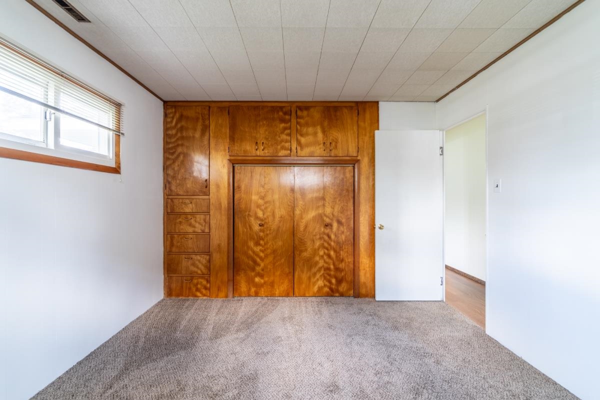Built-in wood cabinetry and closet system provide storage