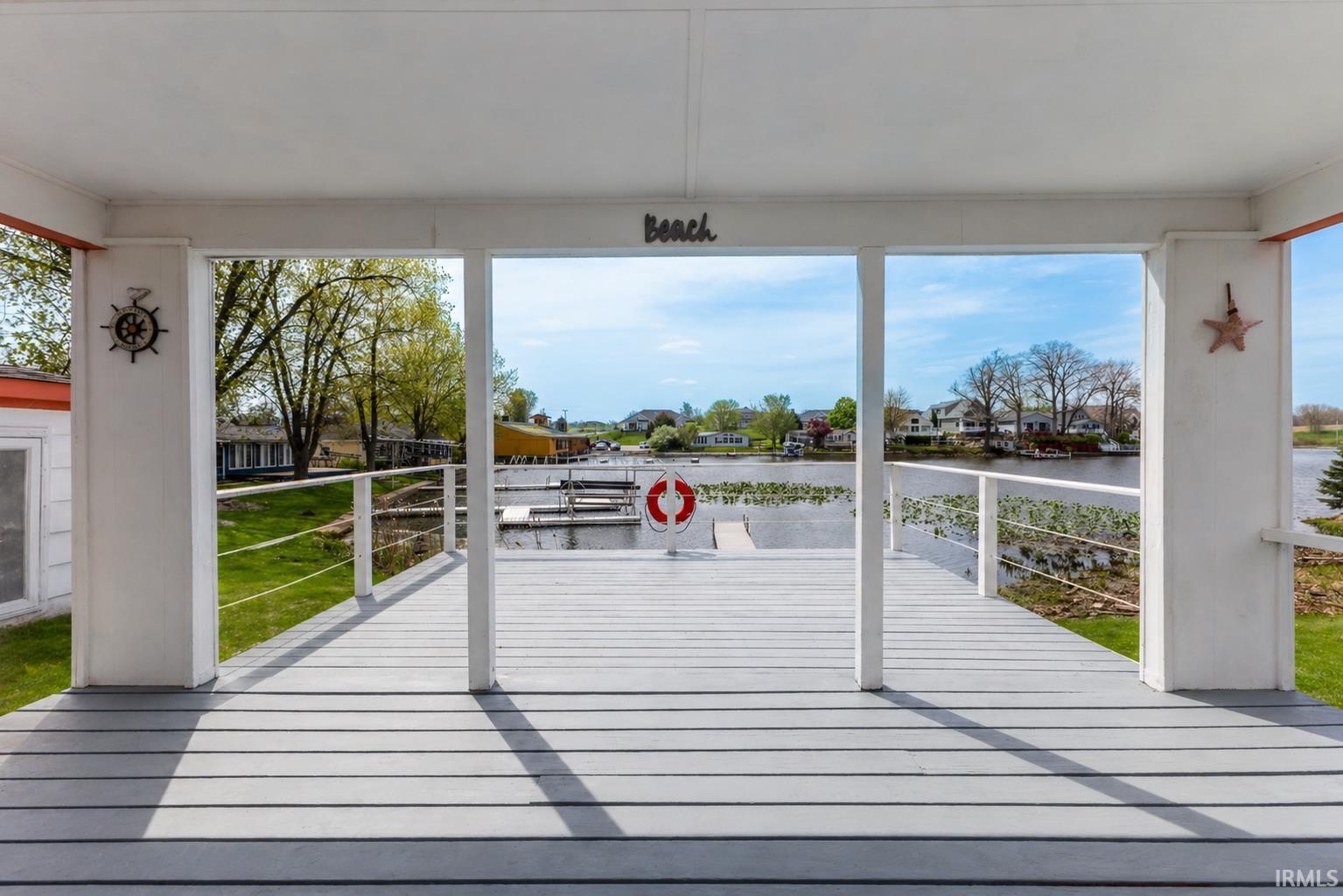 Covered outdoor deck with light gray plank flooring
