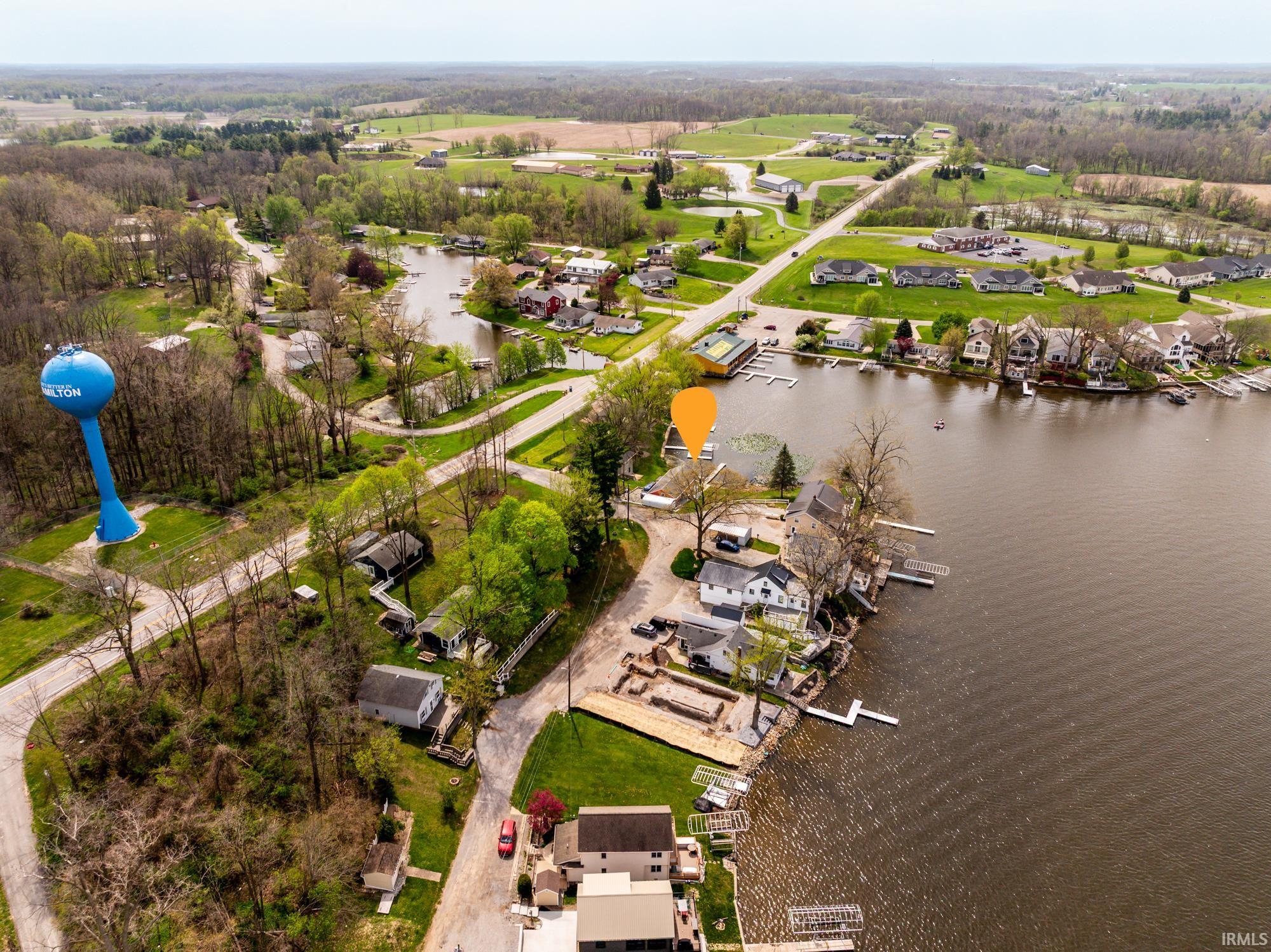 Aerial perspective showcasing waterfront properties along a lake with multiple docks
