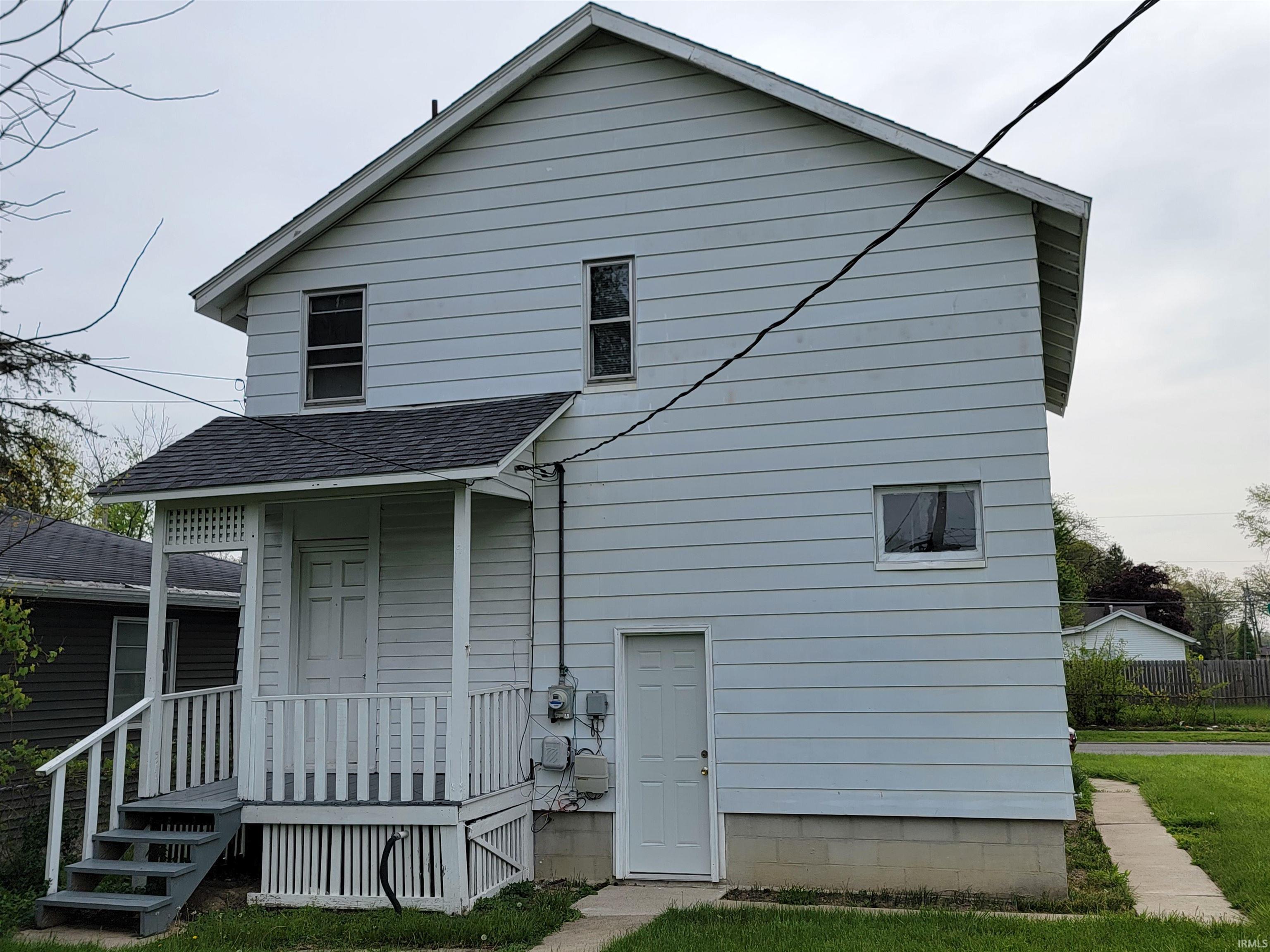 Two-story property featuring horizontal siding and a dark shingle roof
