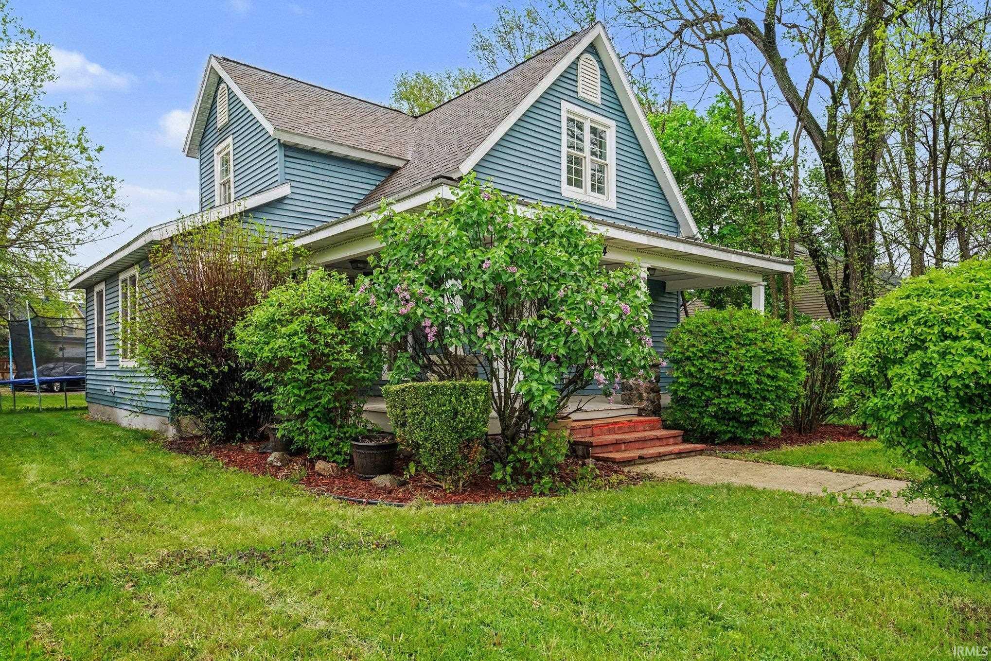 Traditional two-story residence featuring blue siding and white window trim