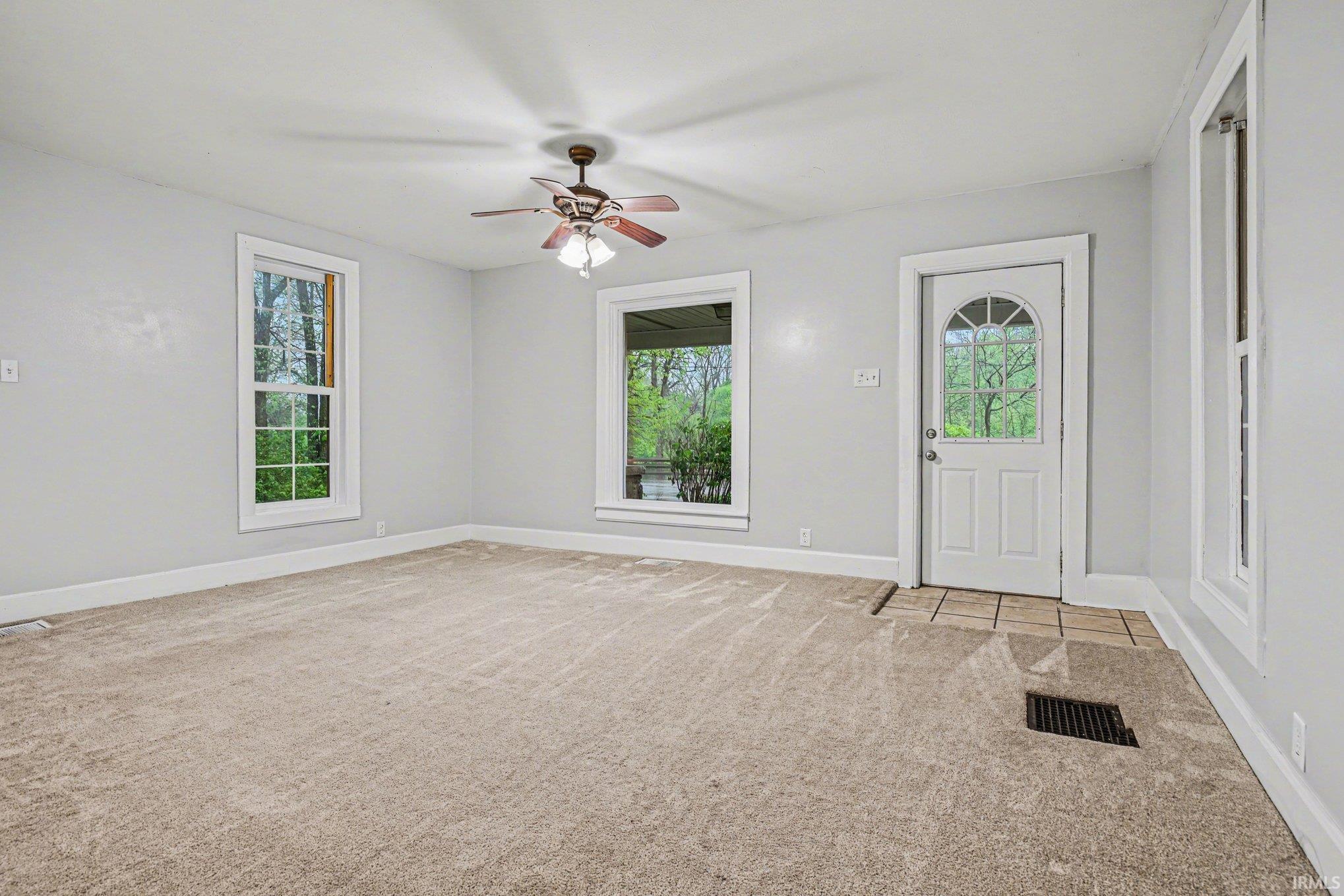 Light gray walls throughout with a textured carpeted floor