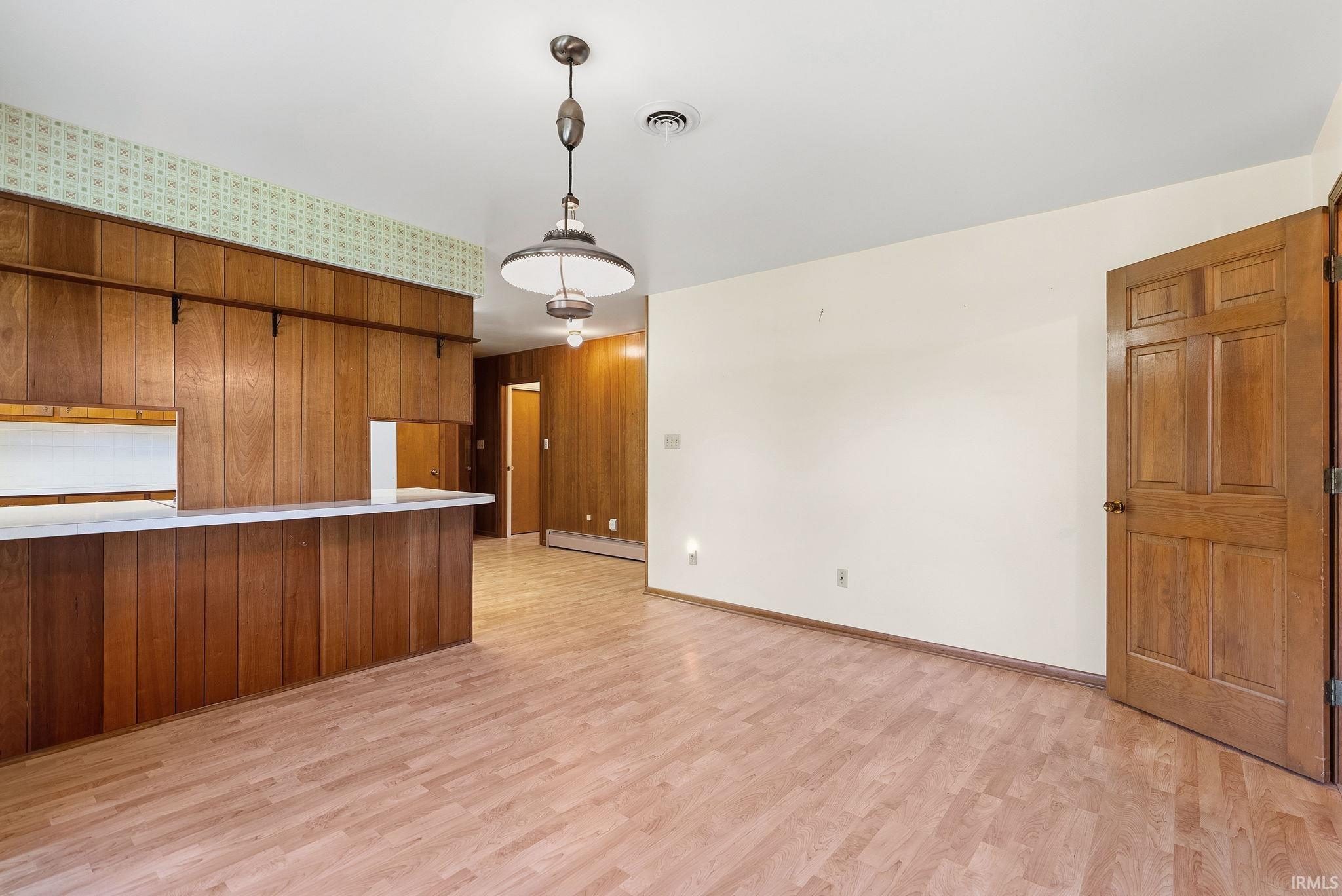 Light wood-finish flooring extending throughout the space