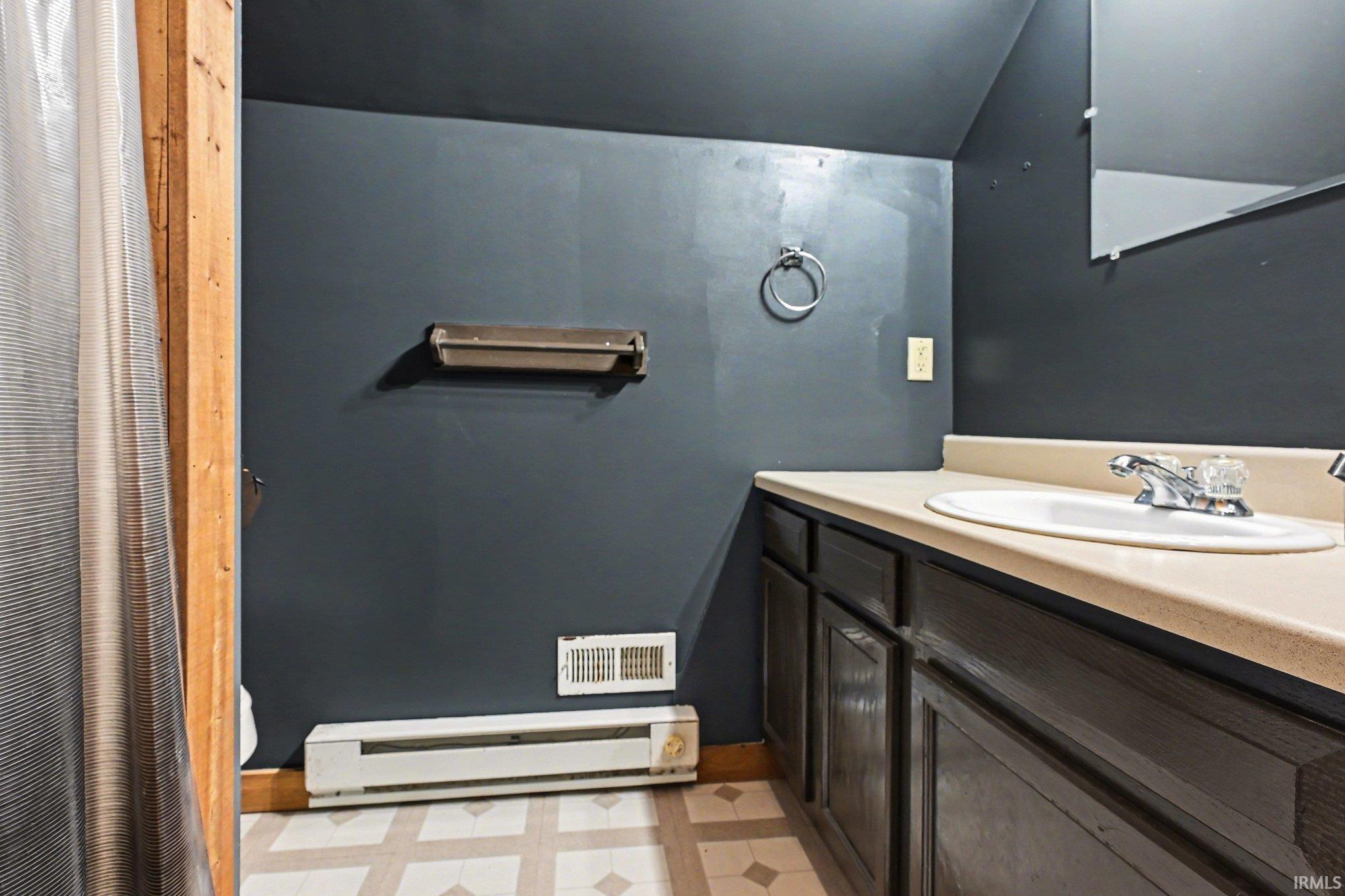 Bathroom vanity with an integrated sink and light-toned countertop