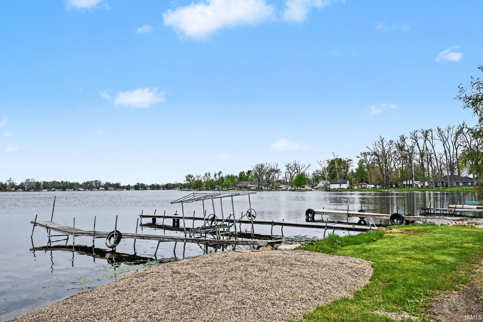 Lakefront property featuring multiple wooden docks and direct water access