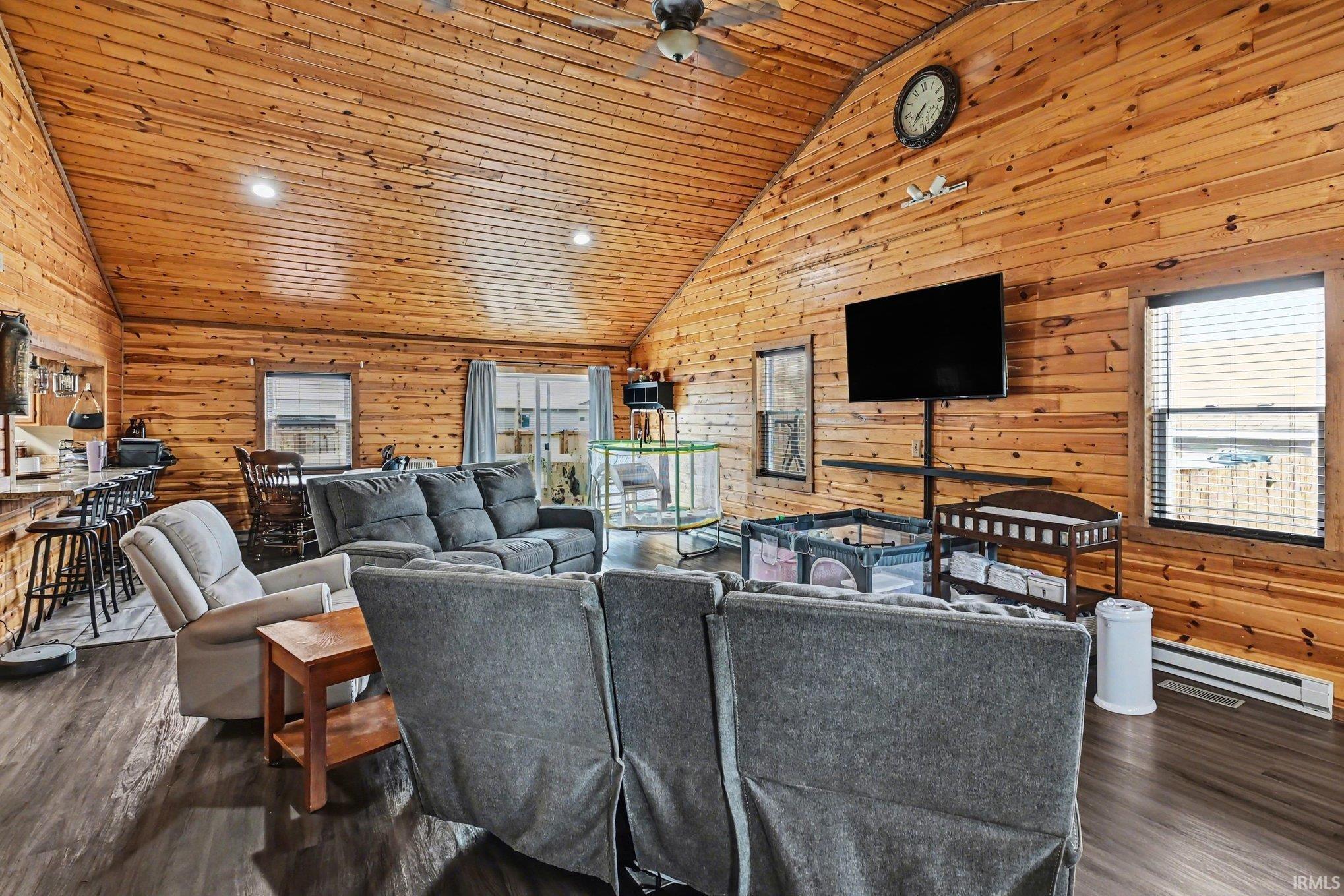 Vaulted ceiling with wood paneling, recessed lighting, and a ceiling fan