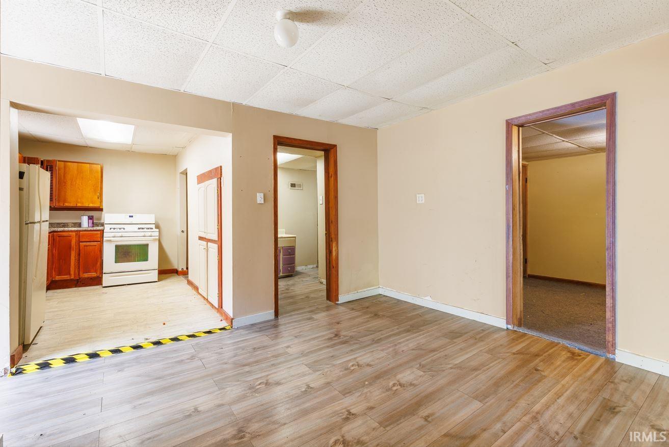 Spacious living area featuring wood-finish flooring and neutral wall tones
