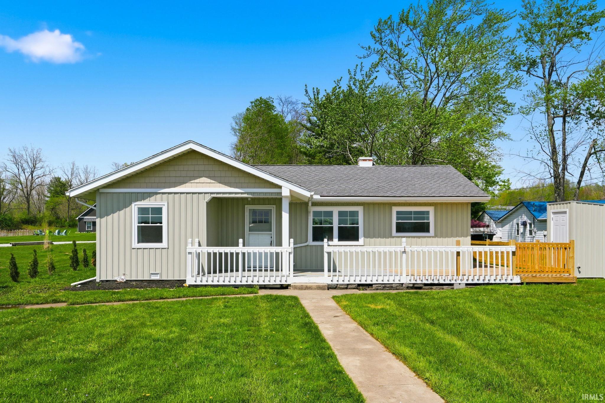 Ranch-style exterior with vertical siding and shingle accents