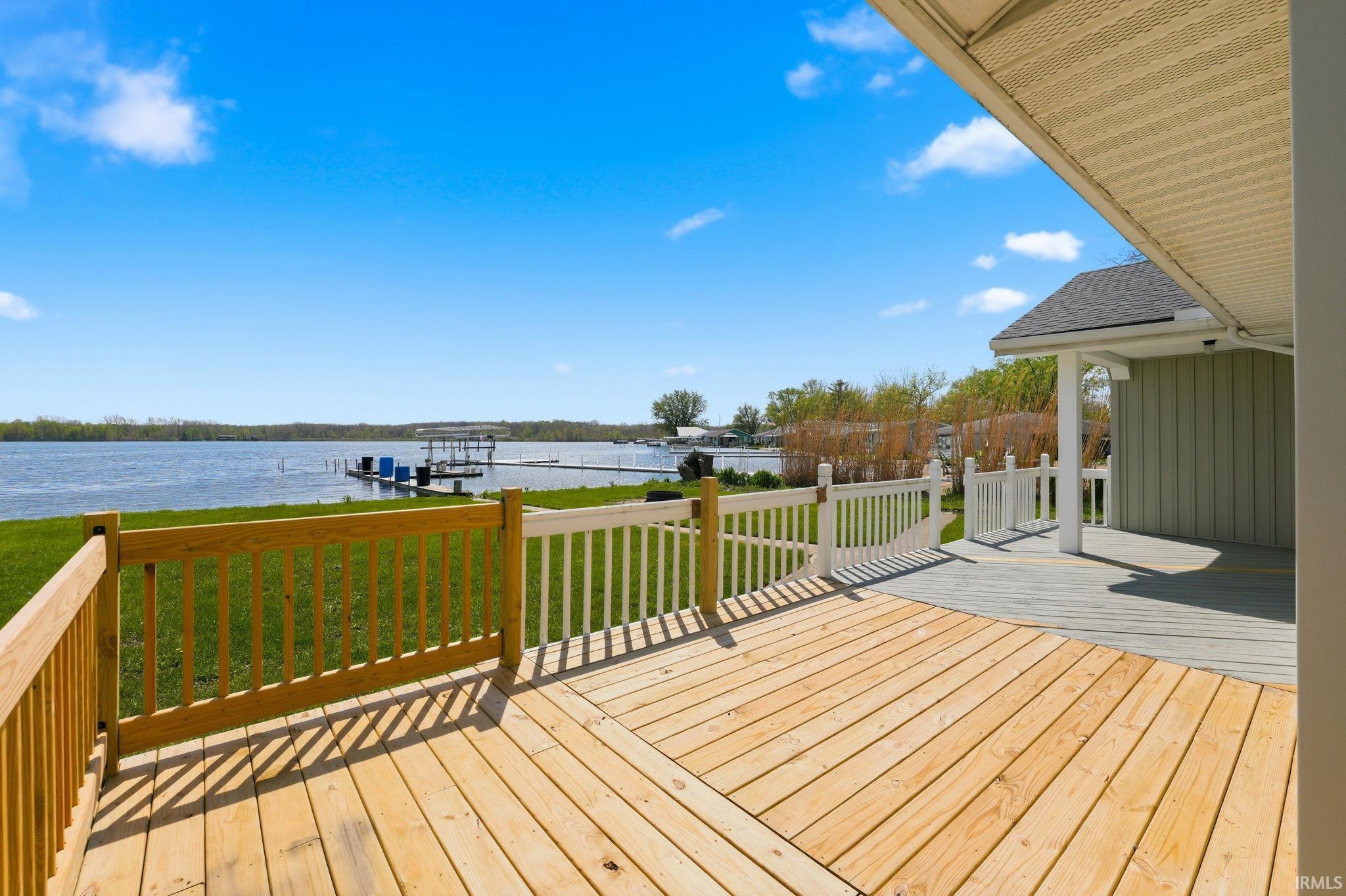 Expansive wood-finish deck featuring a full railing system