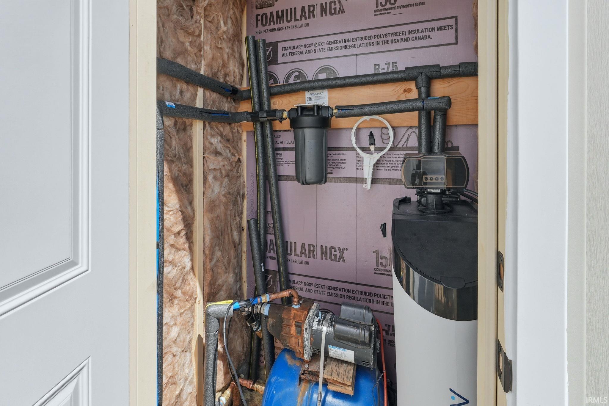 Mechanical closet featuring a water filtration system, water softener, and insulated piping
