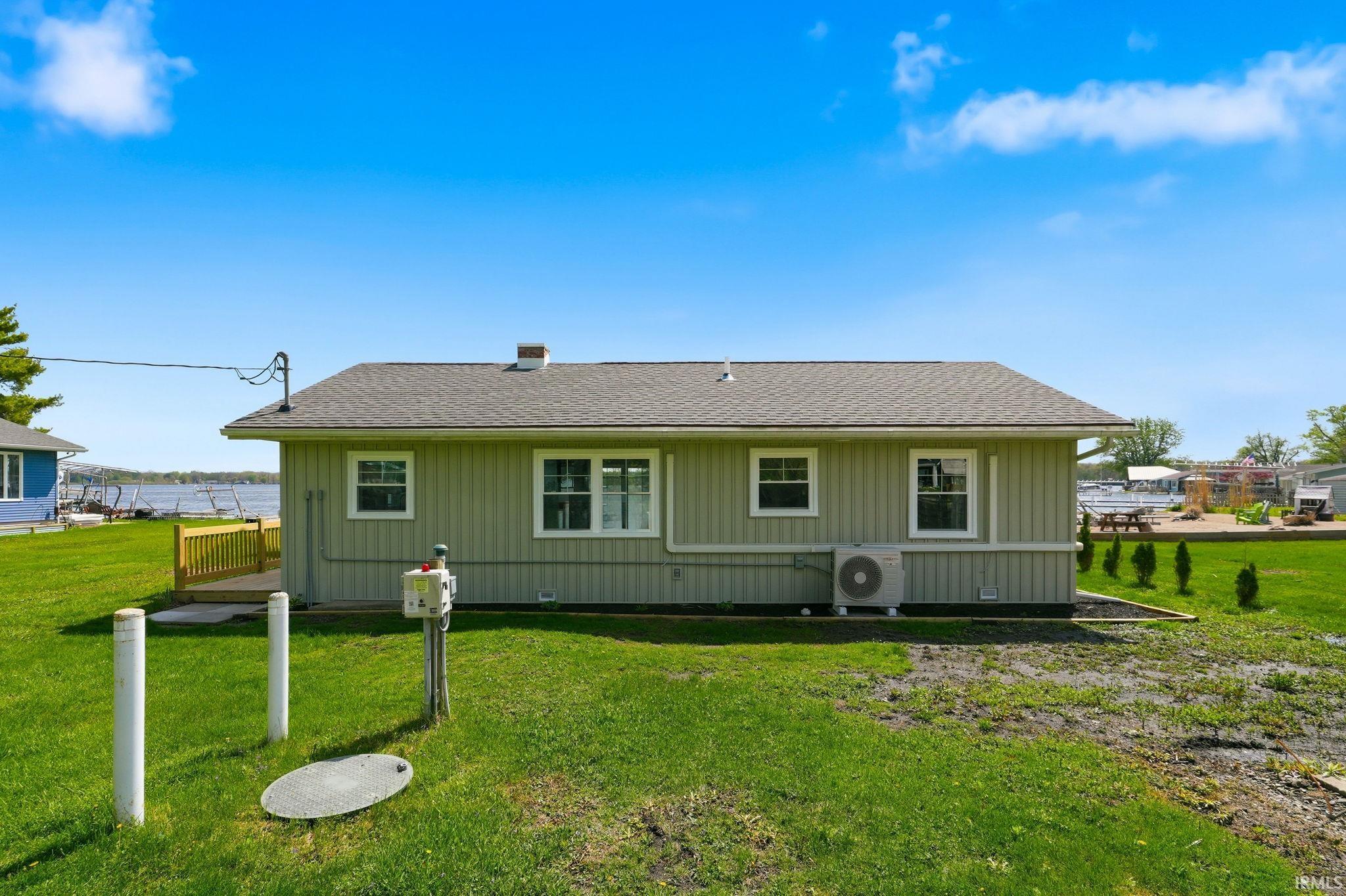 Light green horizontal siding exterior with a dark shingle roof