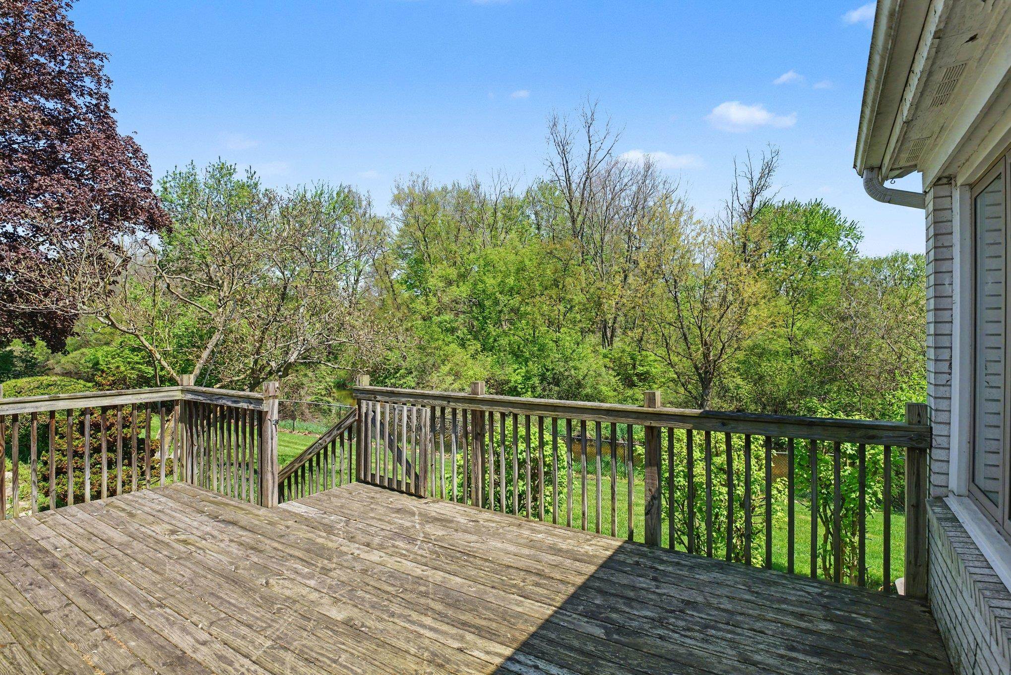 Expansive outdoor deck with natural wood surface and railing