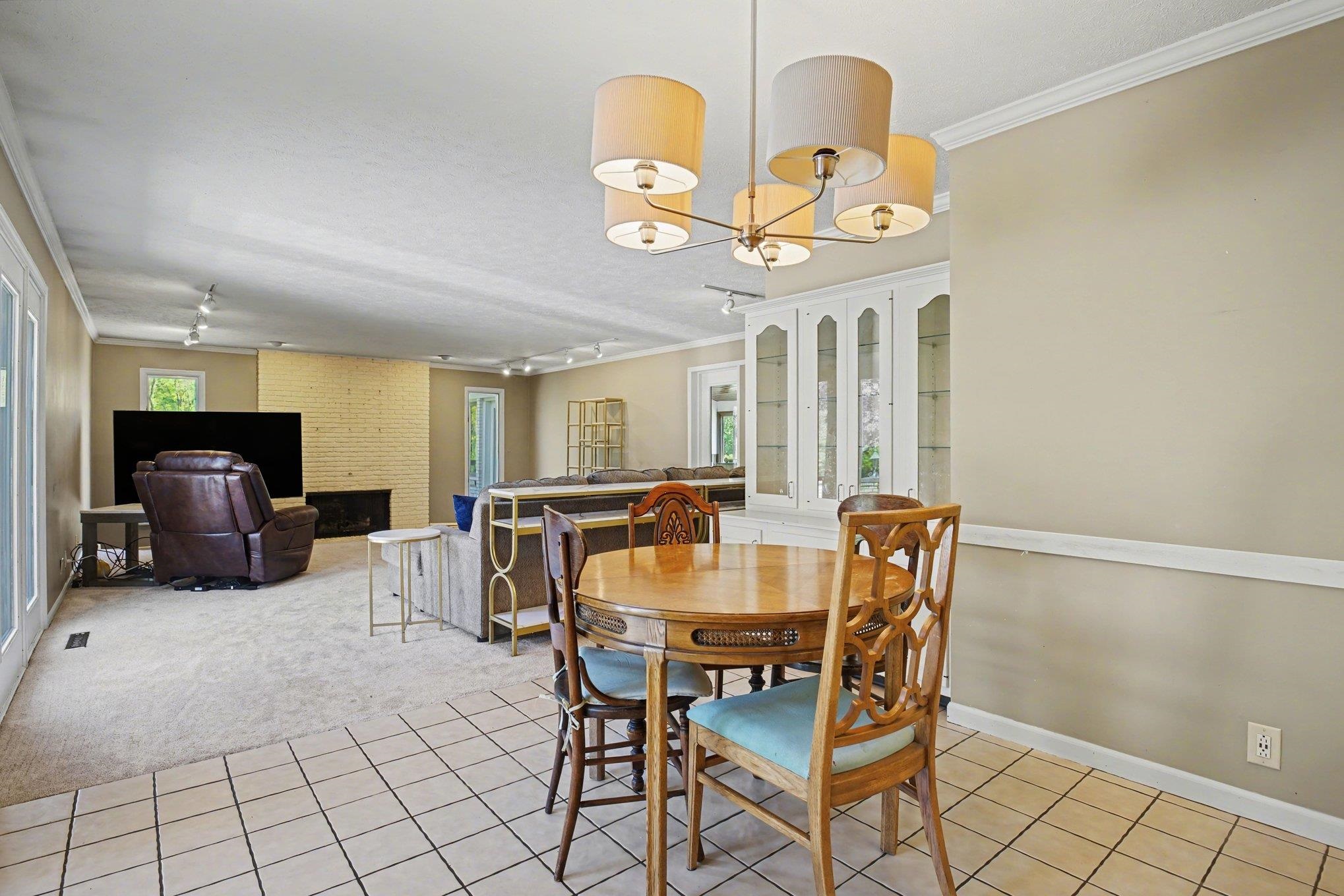 Open-concept living space featuring a distinct tiled dining breakfast area