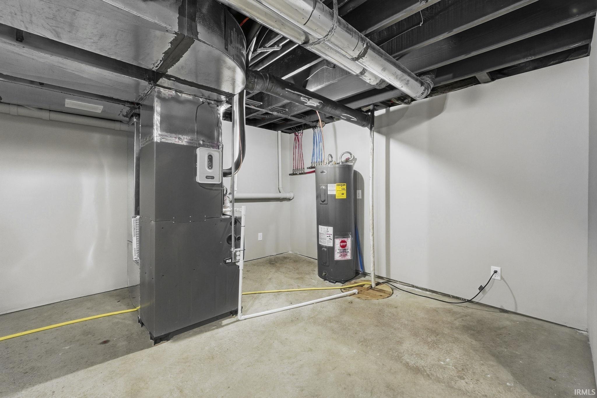Below grade area with heating unit and water heater