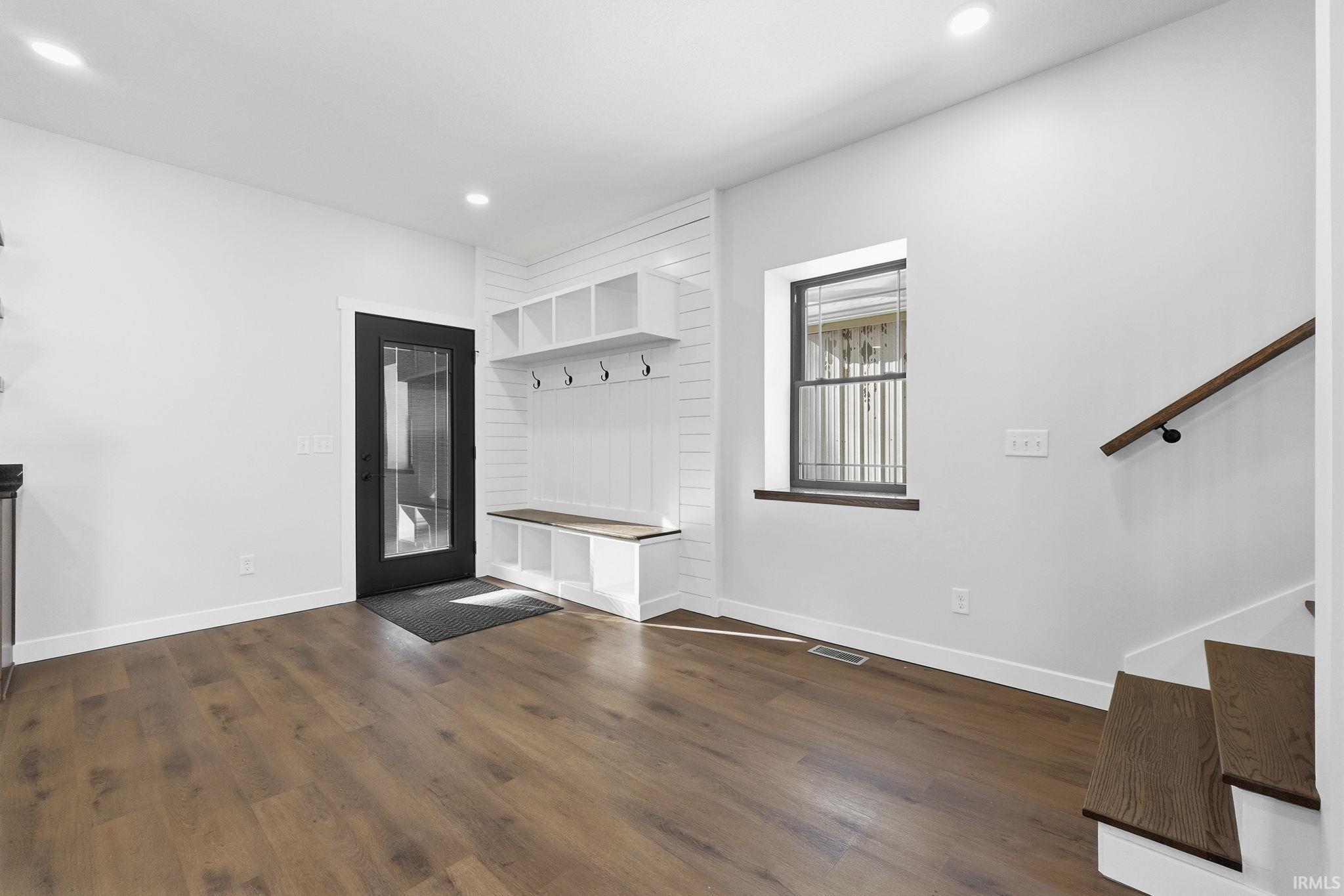 Mudroom featuring dark wood-type flooring and recessed lighting