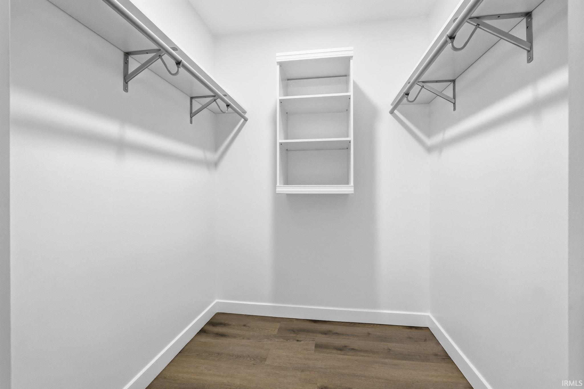Walk in closet featuring dark wood finished floors