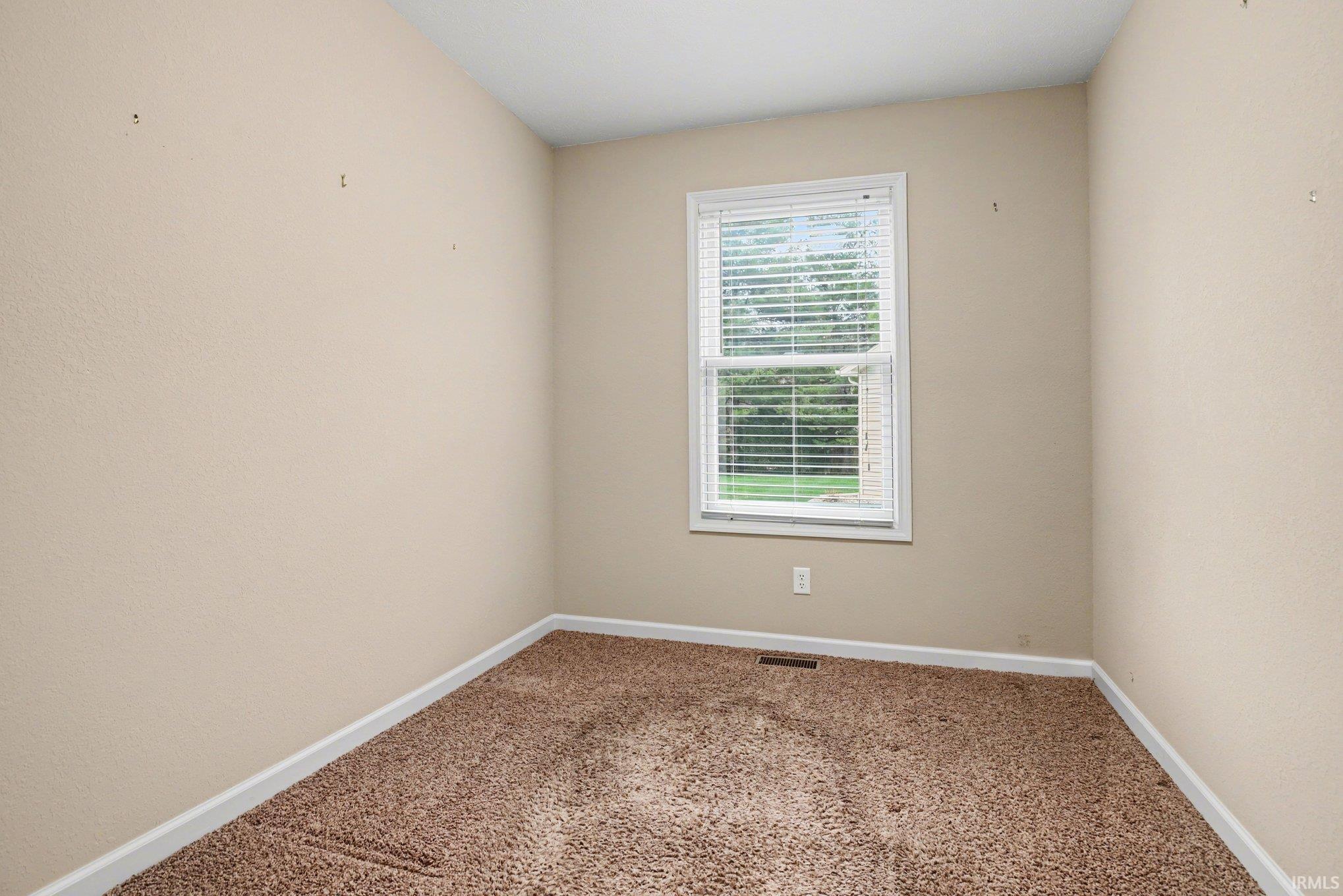Unfurnished room with baseboards and carpet flooring