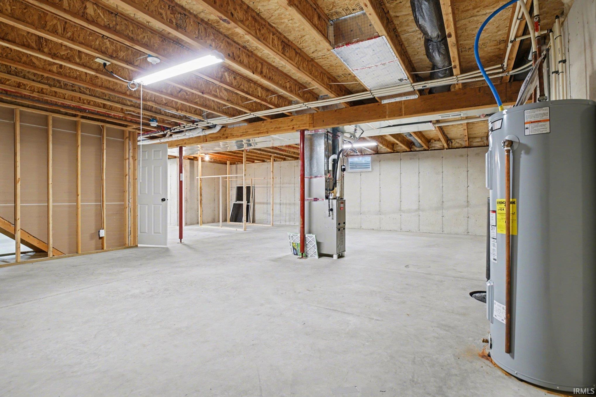 Unfinished basement with water heater and heating unit