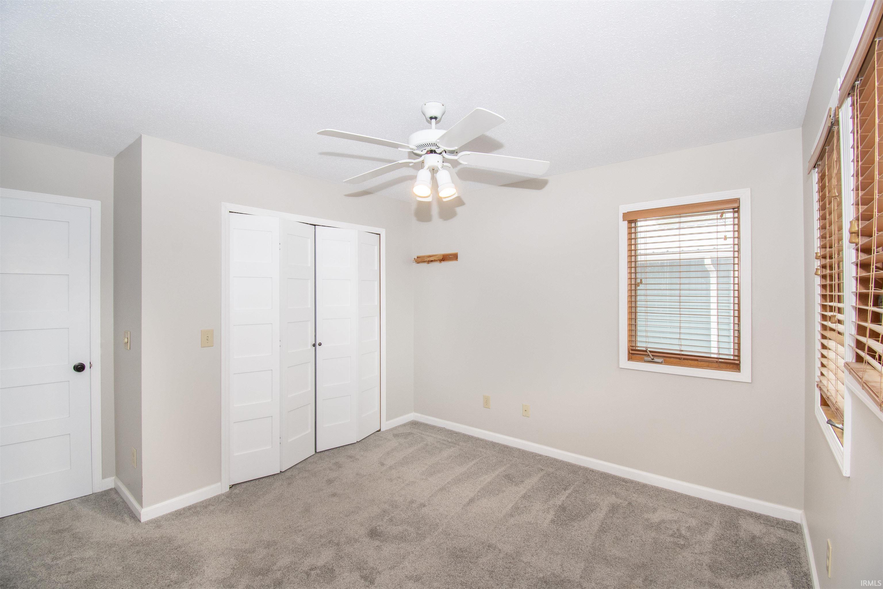 Room featuring light gray carpet flooring and white painted walls